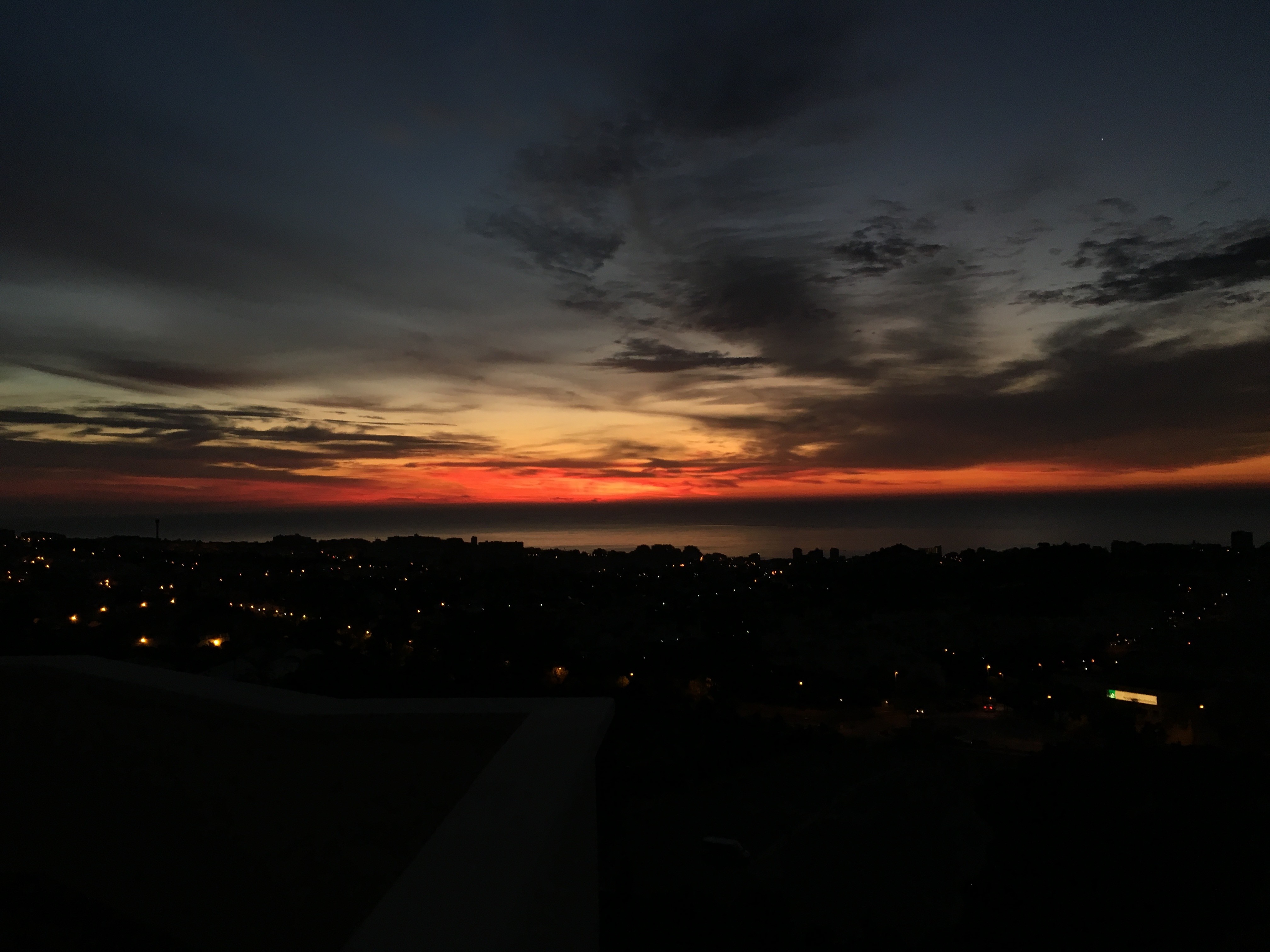 City skyline at sunset over the ocean HD Wallpaper