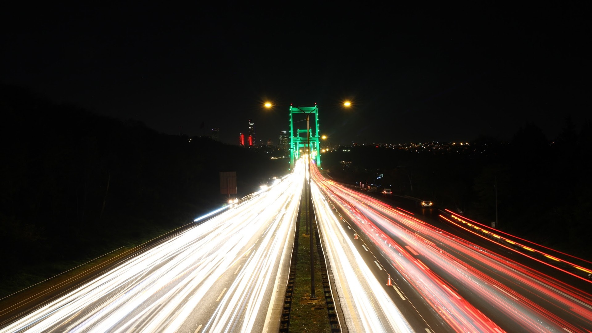Long exposure of a bridge at night with light trails HD Wallpaper