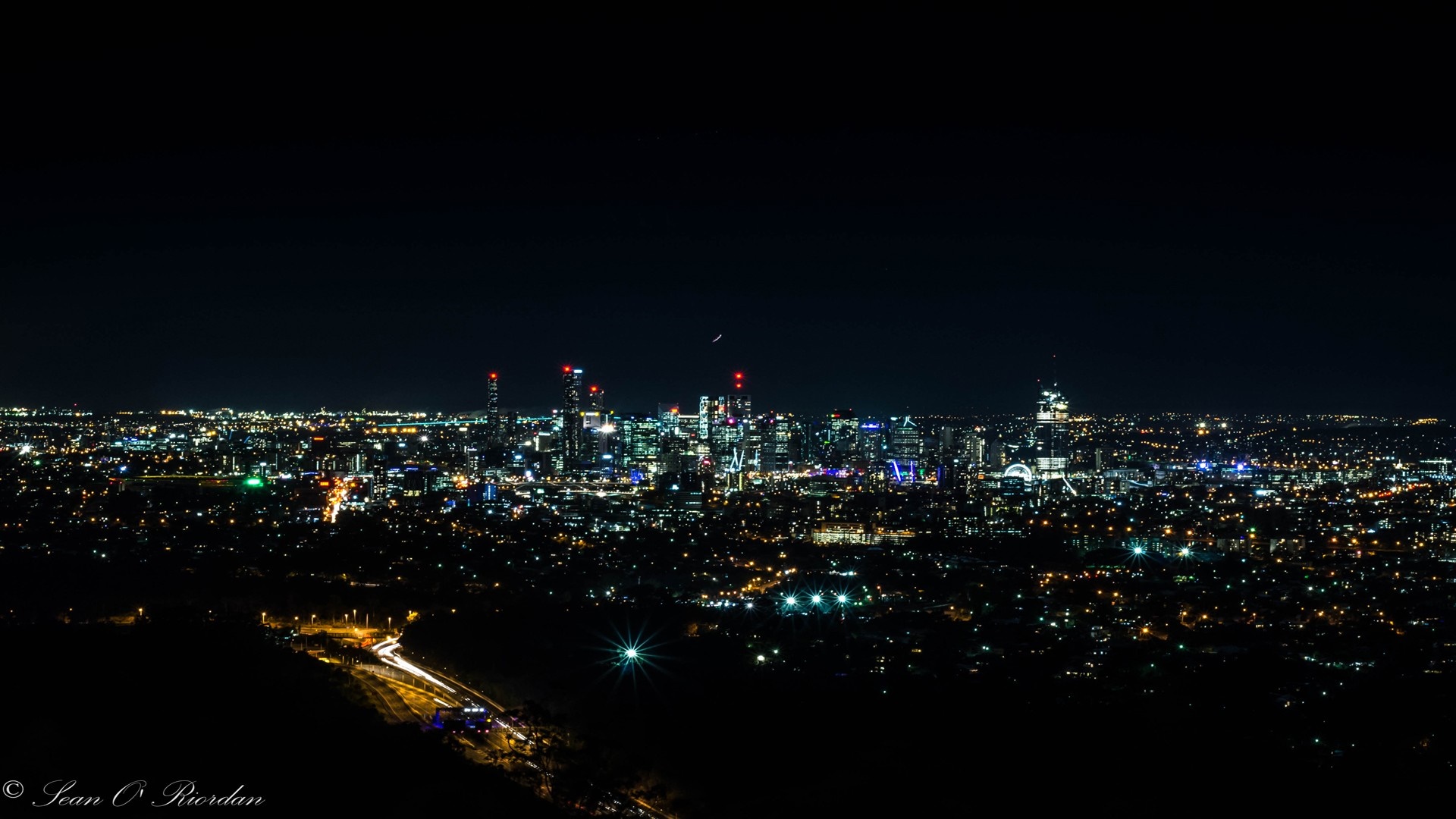 Cityscape at night with illuminated skyscrapers and lights HD Wallpaper