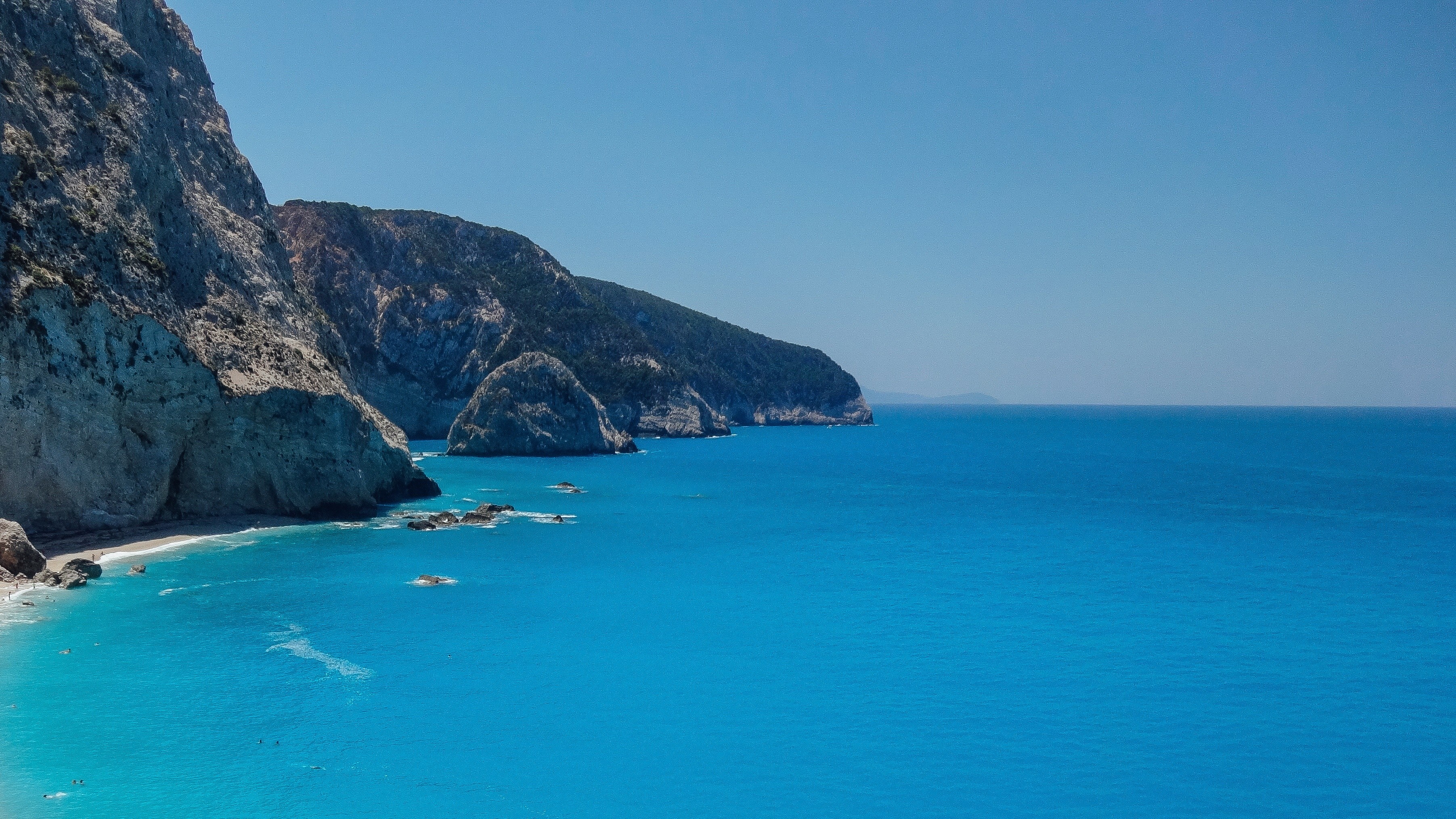 Turquoise water and cliffs on a sunny day HD Wallpaper