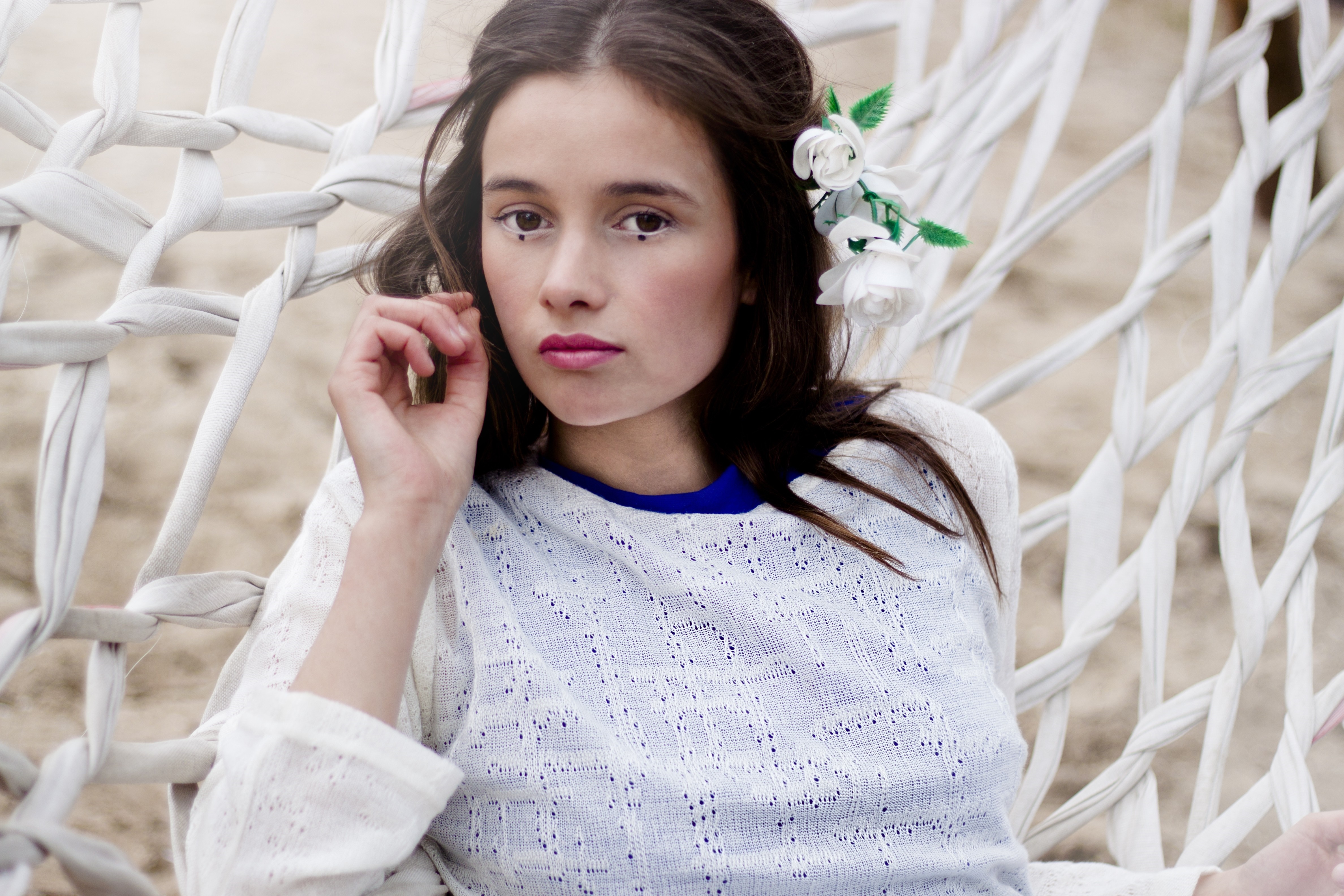 Woman with flowers in her hair lying in a hammock HD Wallpaper
