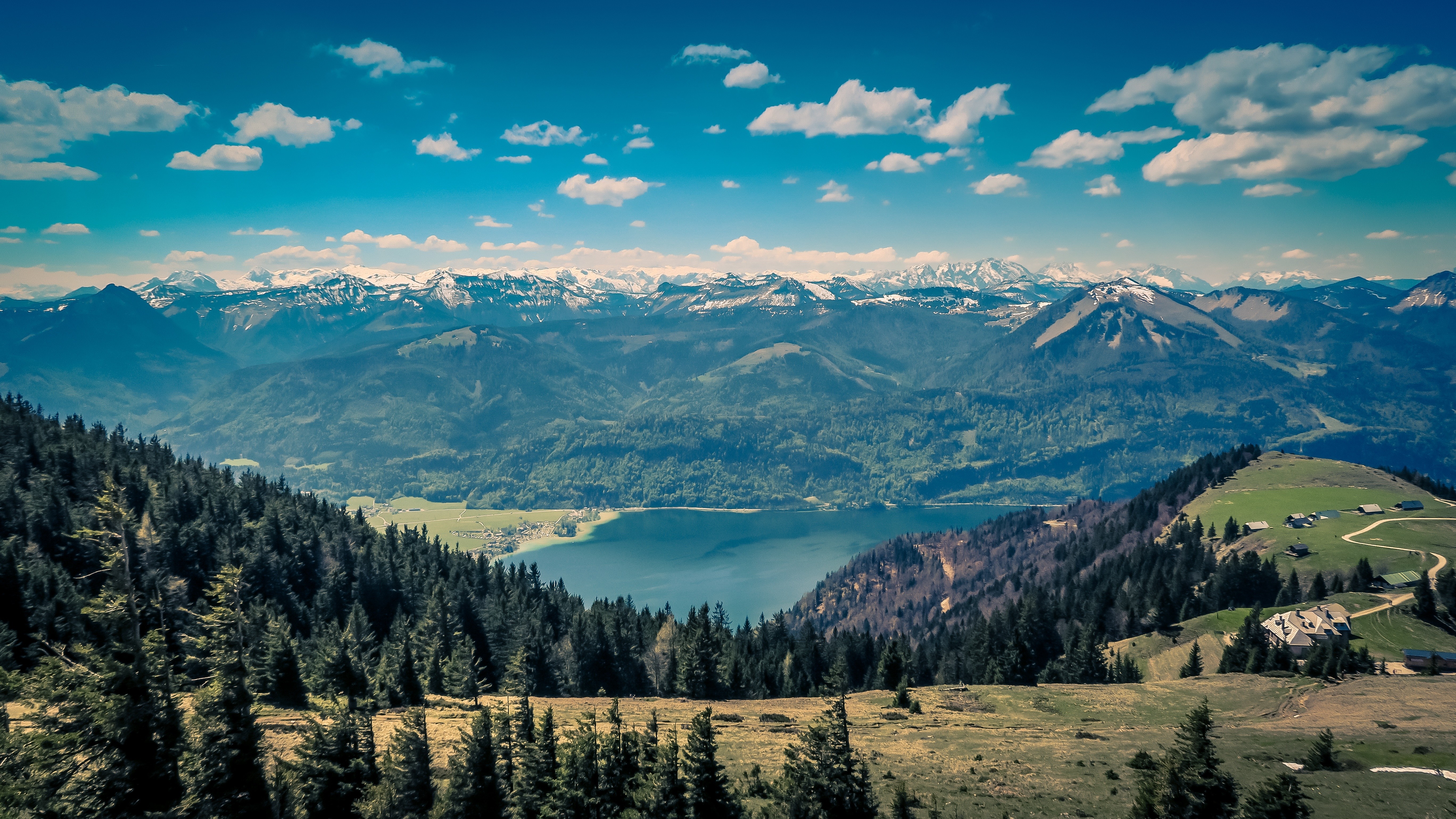 Panoramic view of a mountain range with a lake and forest HD Wallpaper