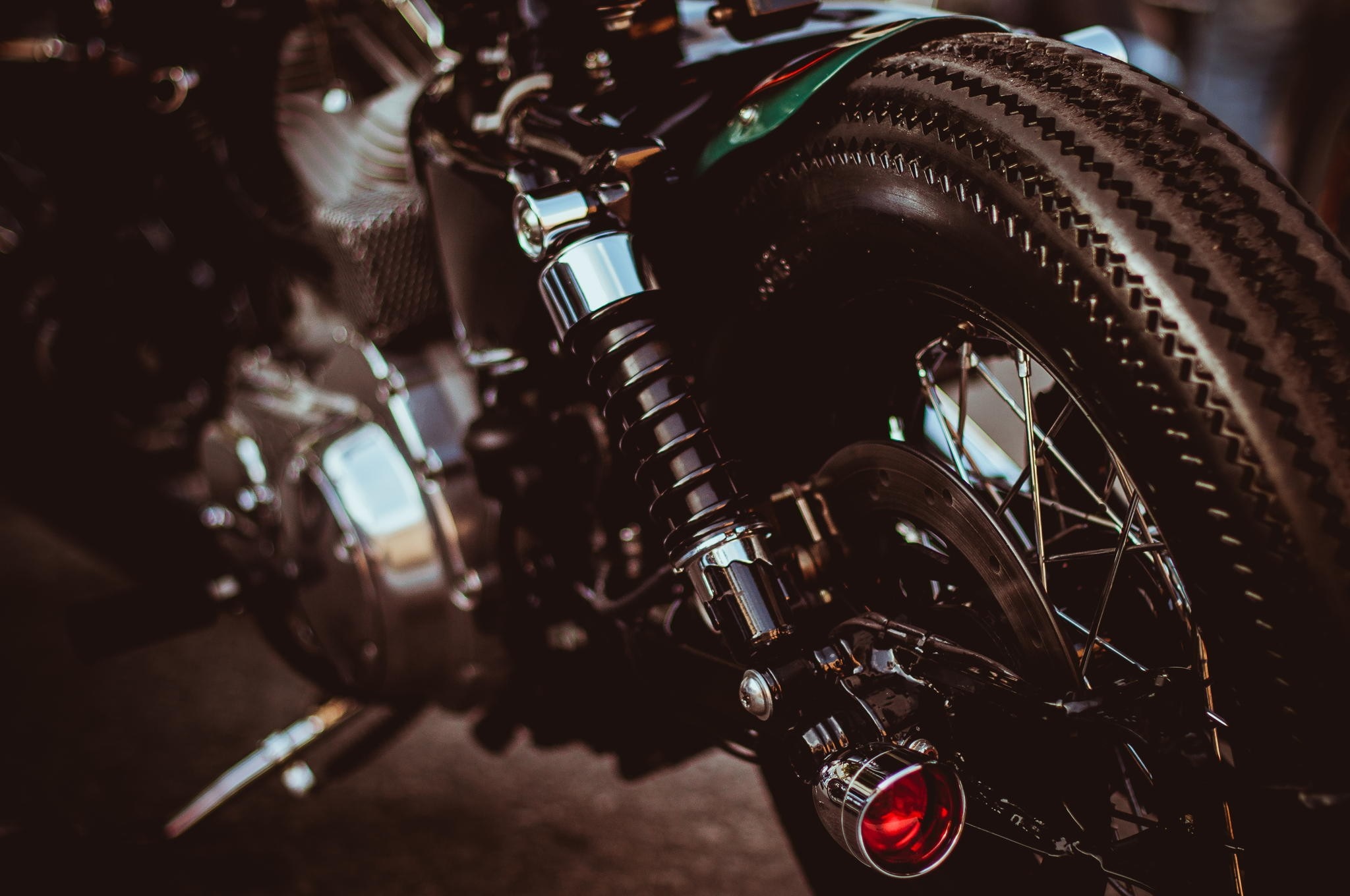 Close-up of a motorcycle's rear wheel and shock absorber HD Wallpaper