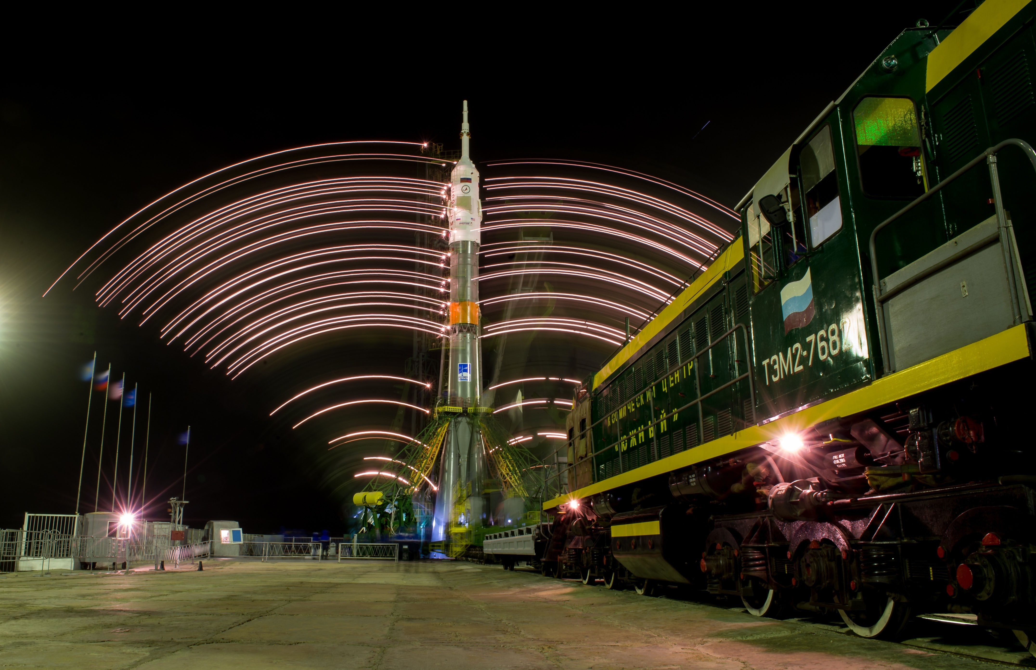 Soyuz rocket and train at Baikonur Cosmodrome at night HD Wallpaper