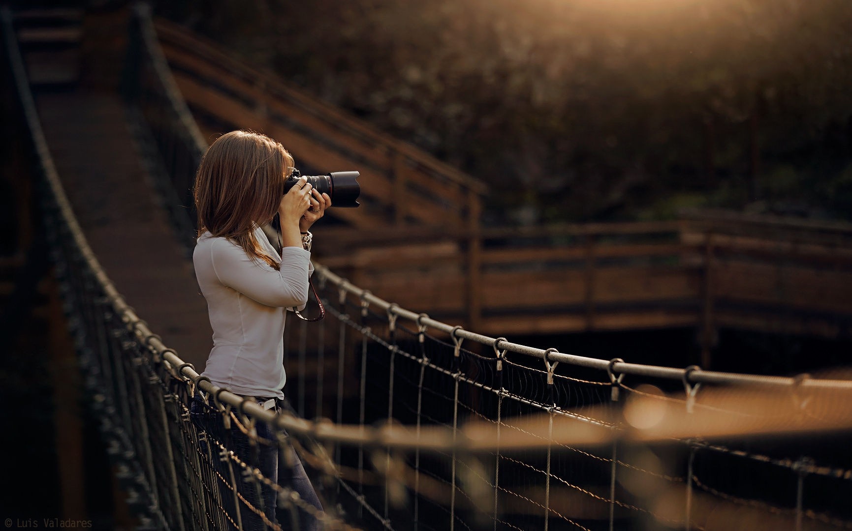 Woman with camera on a bridge at sunset HD Wallpaper