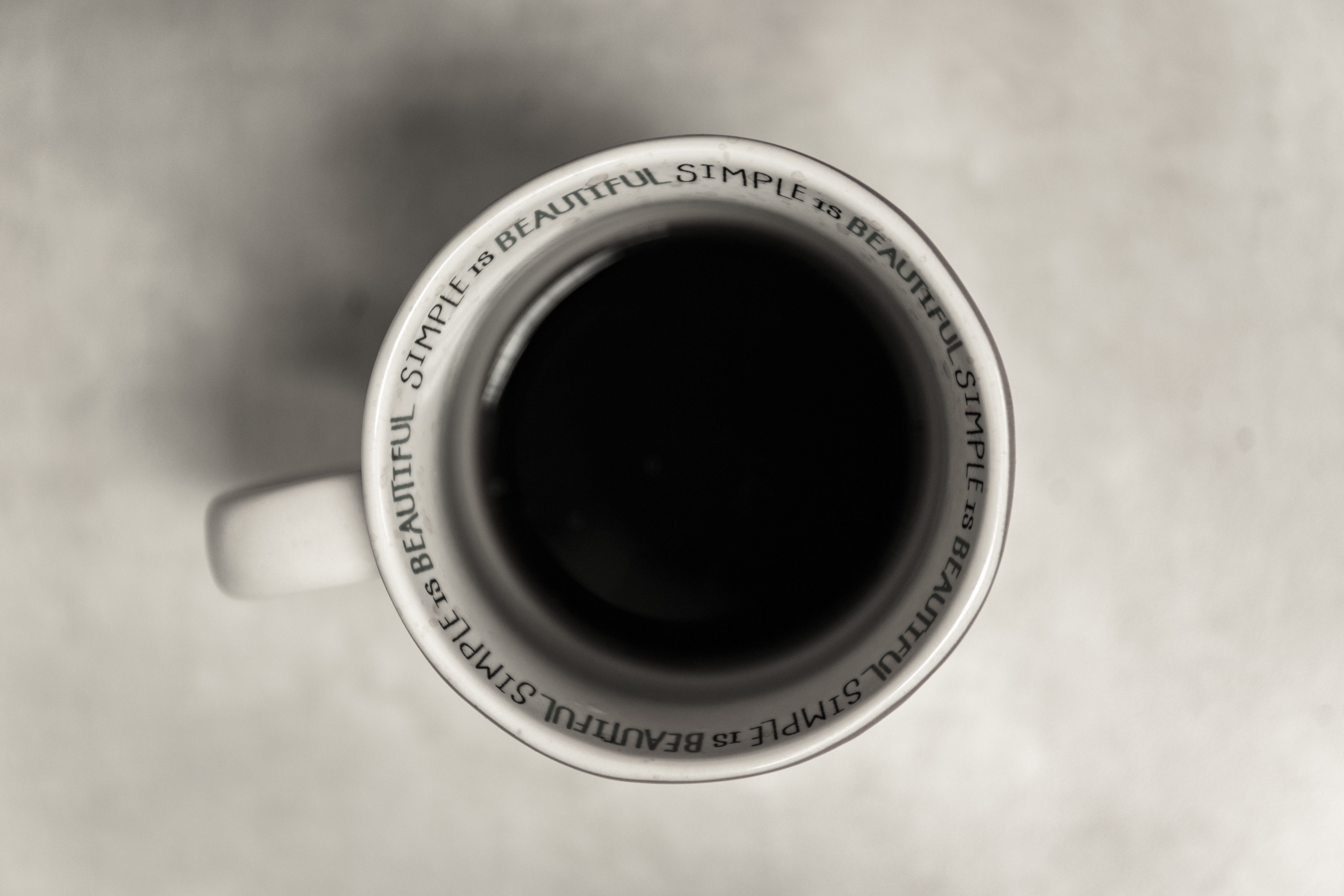Overhead view of a coffee cup with text HD Wallpaper