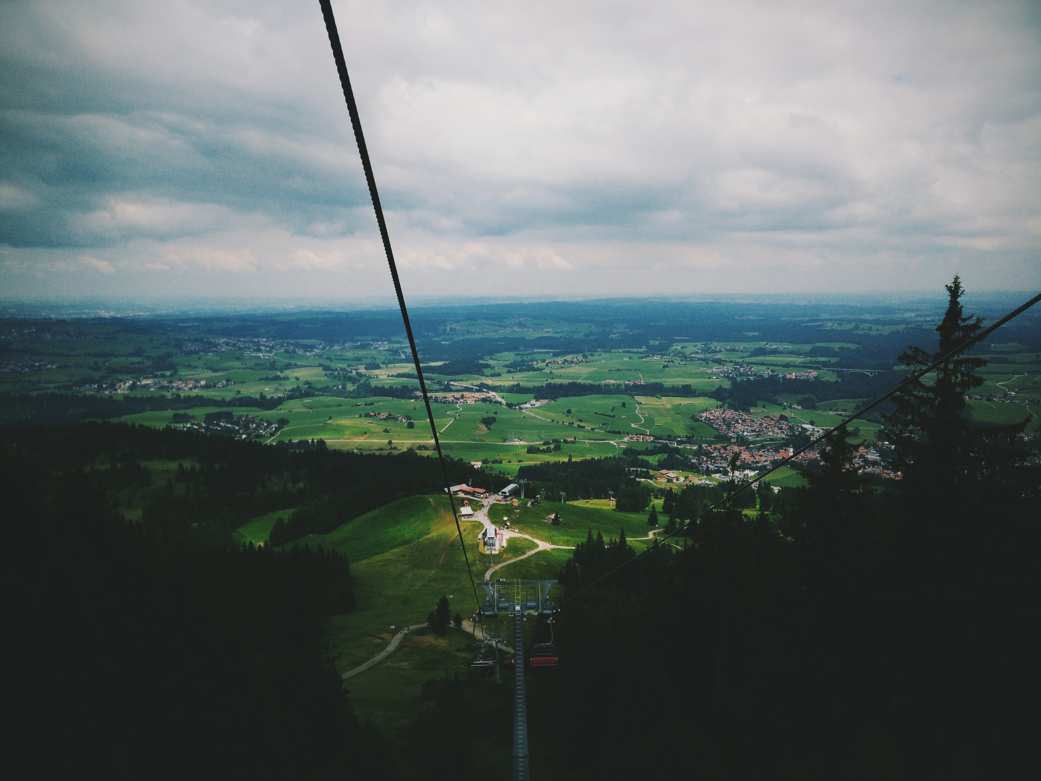 View from a ski lift over a green valley HD Wallpaper