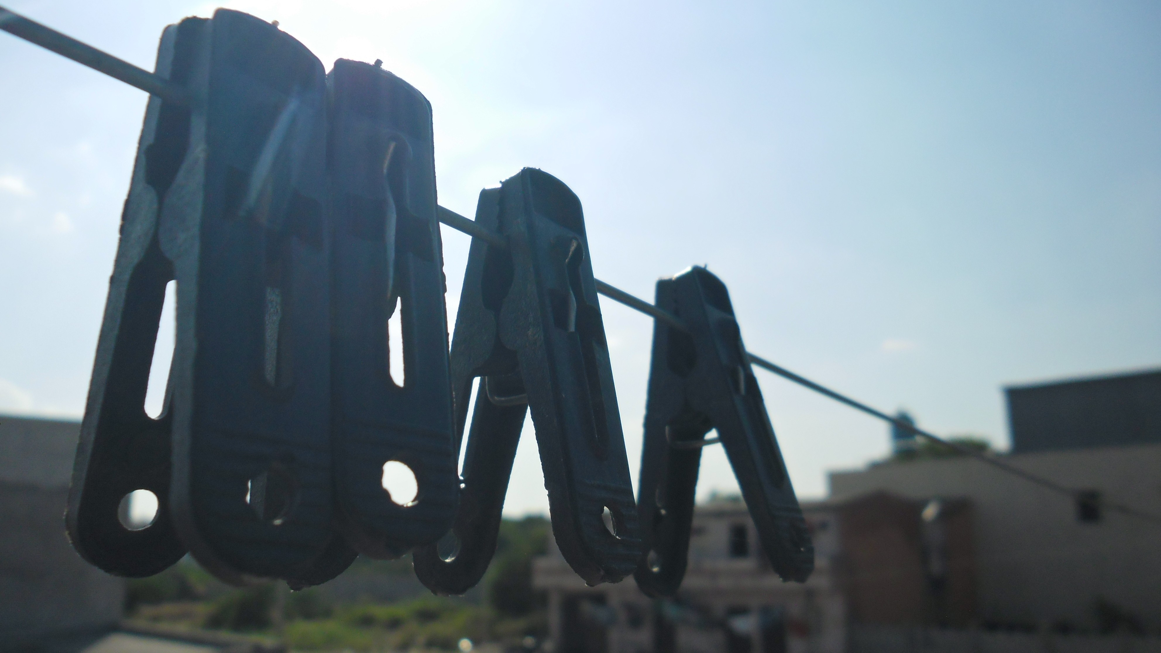 Clothes pegs on a clothesline against the sky HD Wallpaper