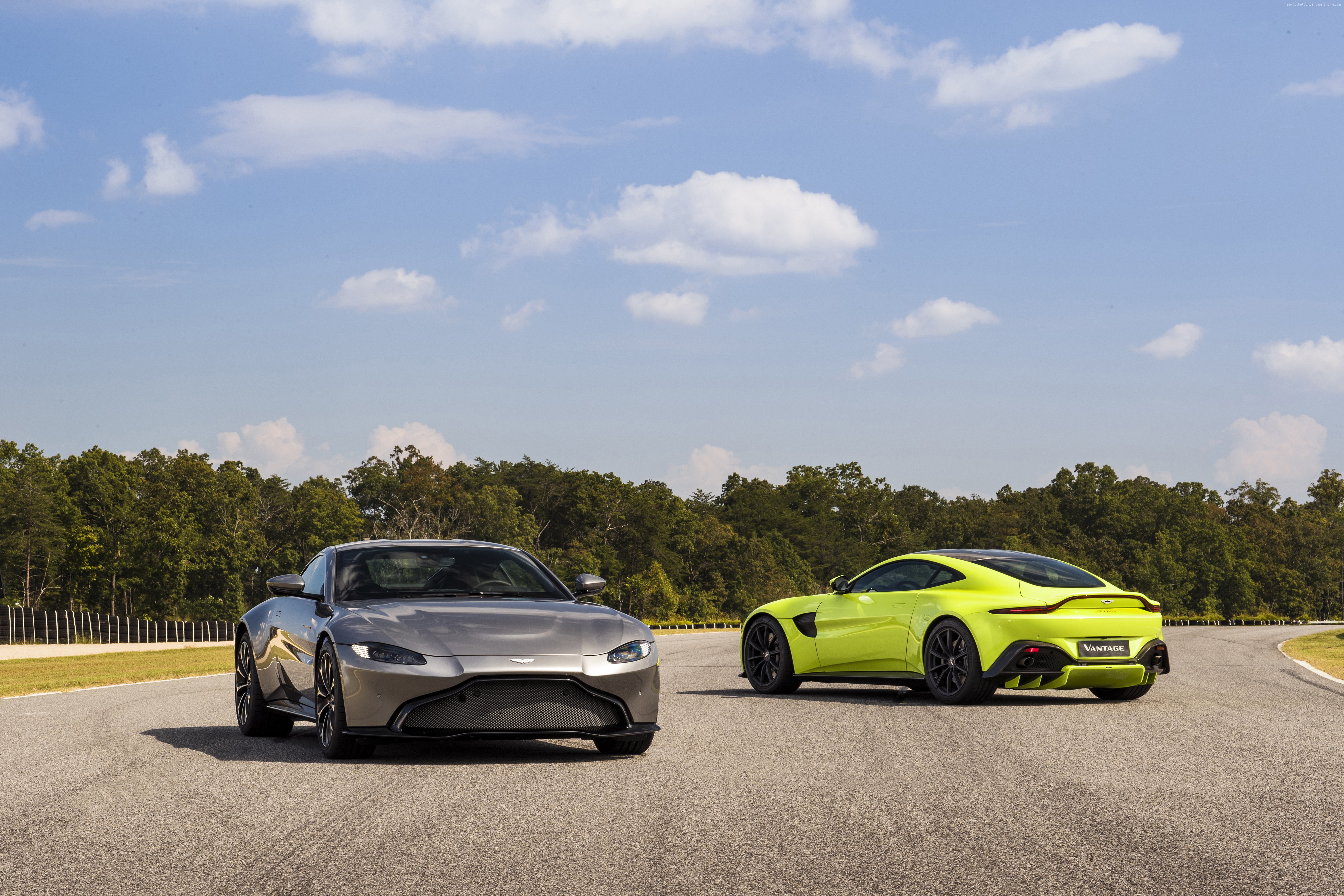 Two Aston Martin Vantage cars on a track HD Wallpaper
