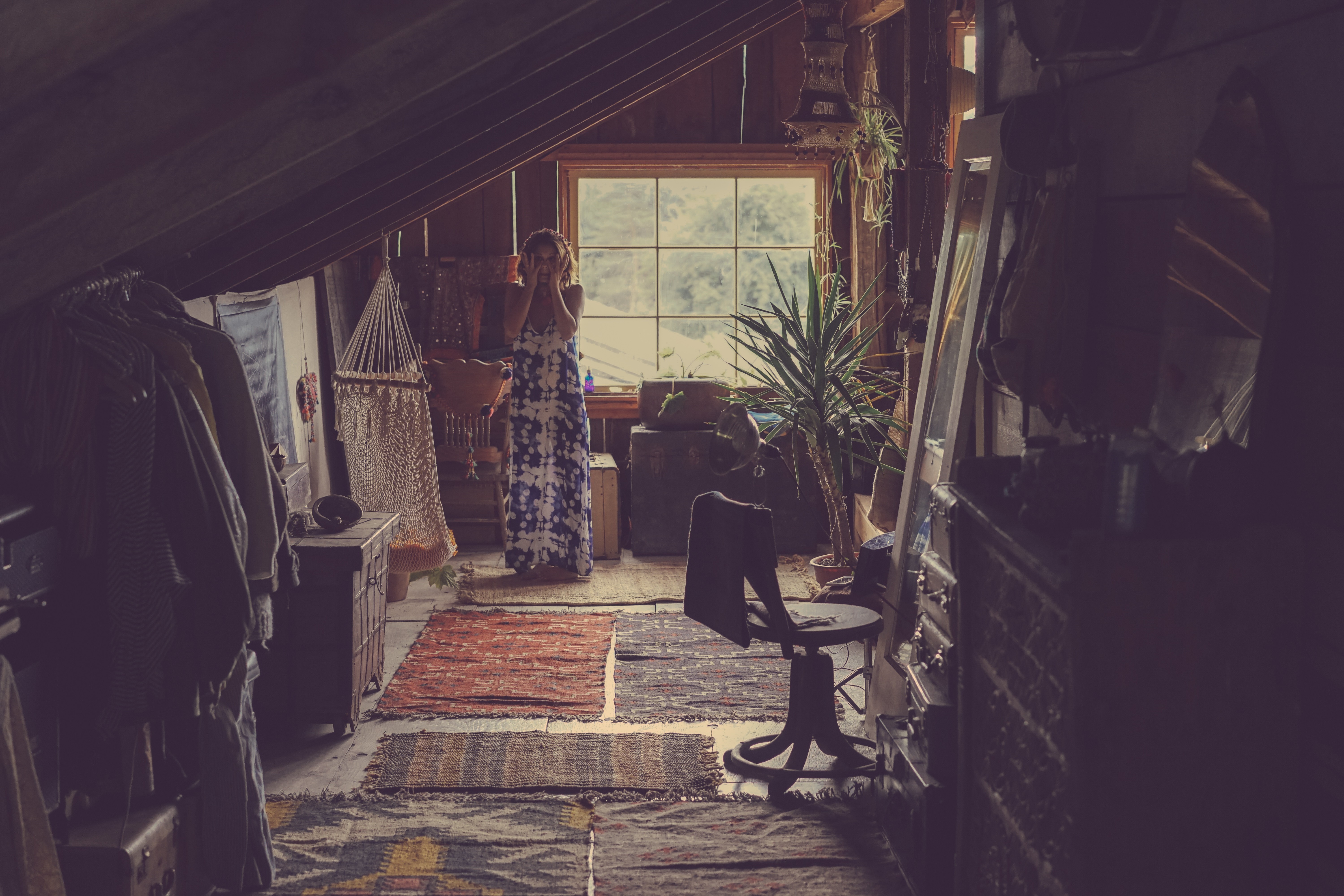 Woman in a dress in a cluttered attic room HD Wallpaper