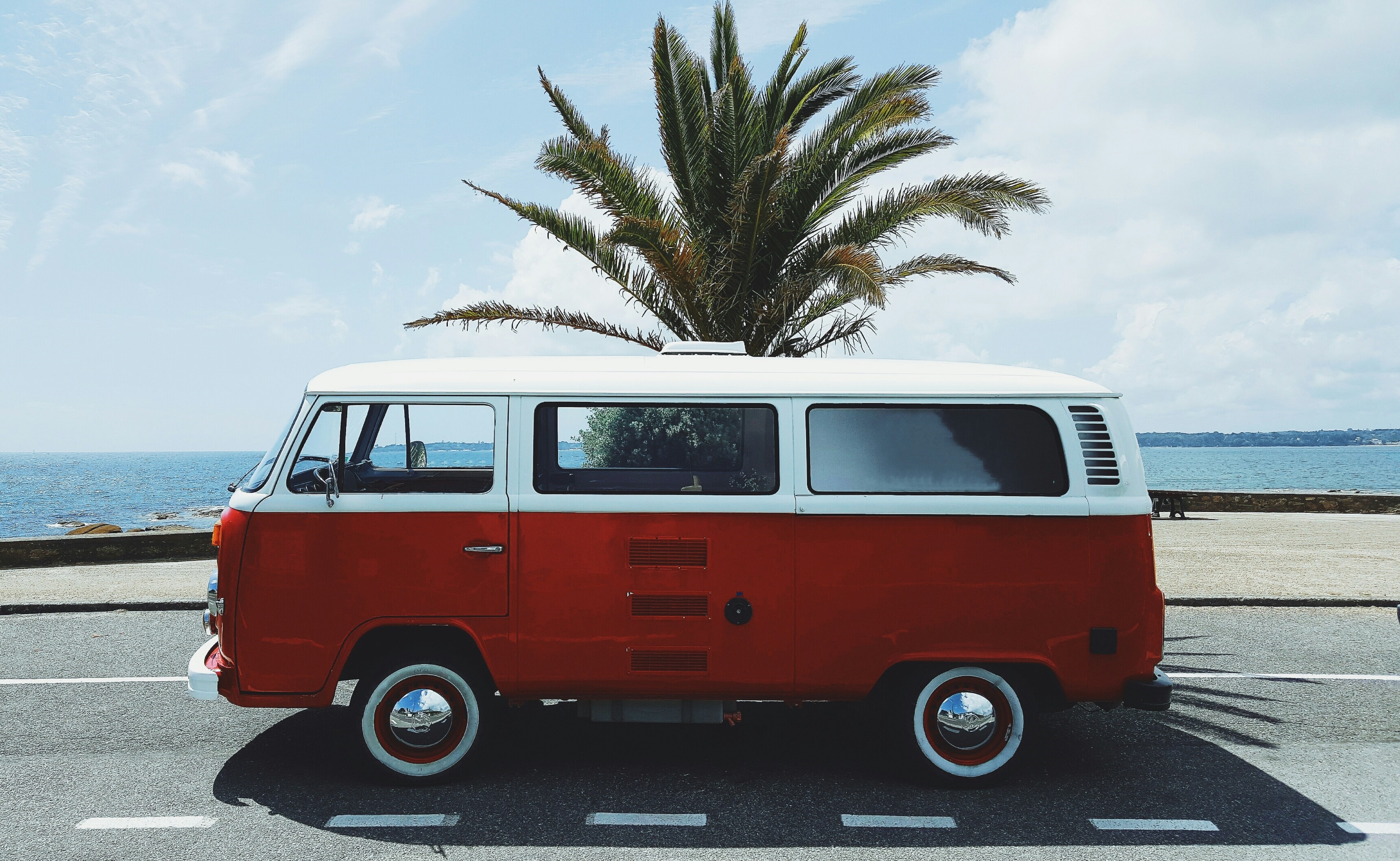Red and white Volkswagen Type 2 van by the sea HD Wallpaper