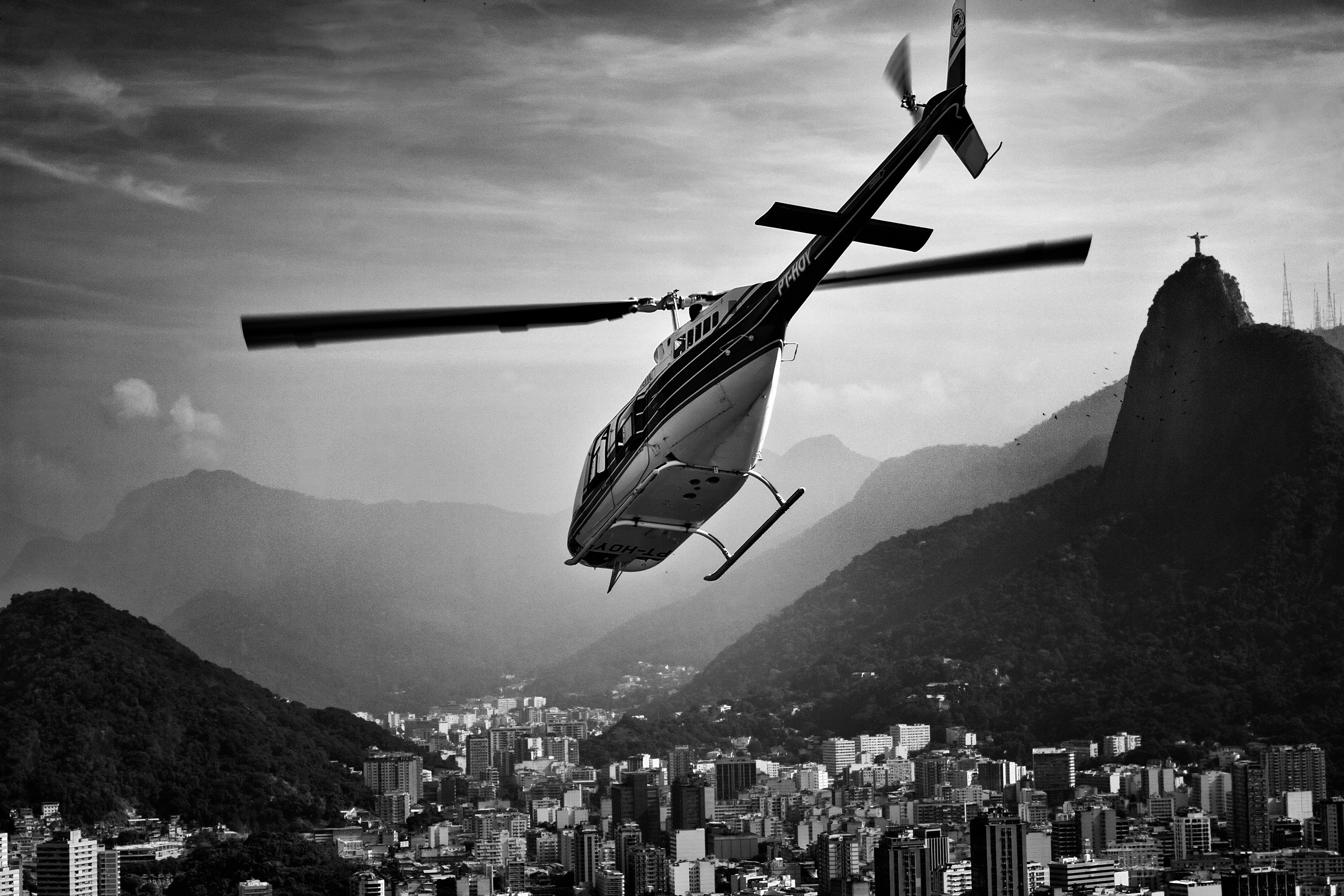 Helicopter flying over Rio de Janeiro with Christ the Redeemer statue HD Wallpaper