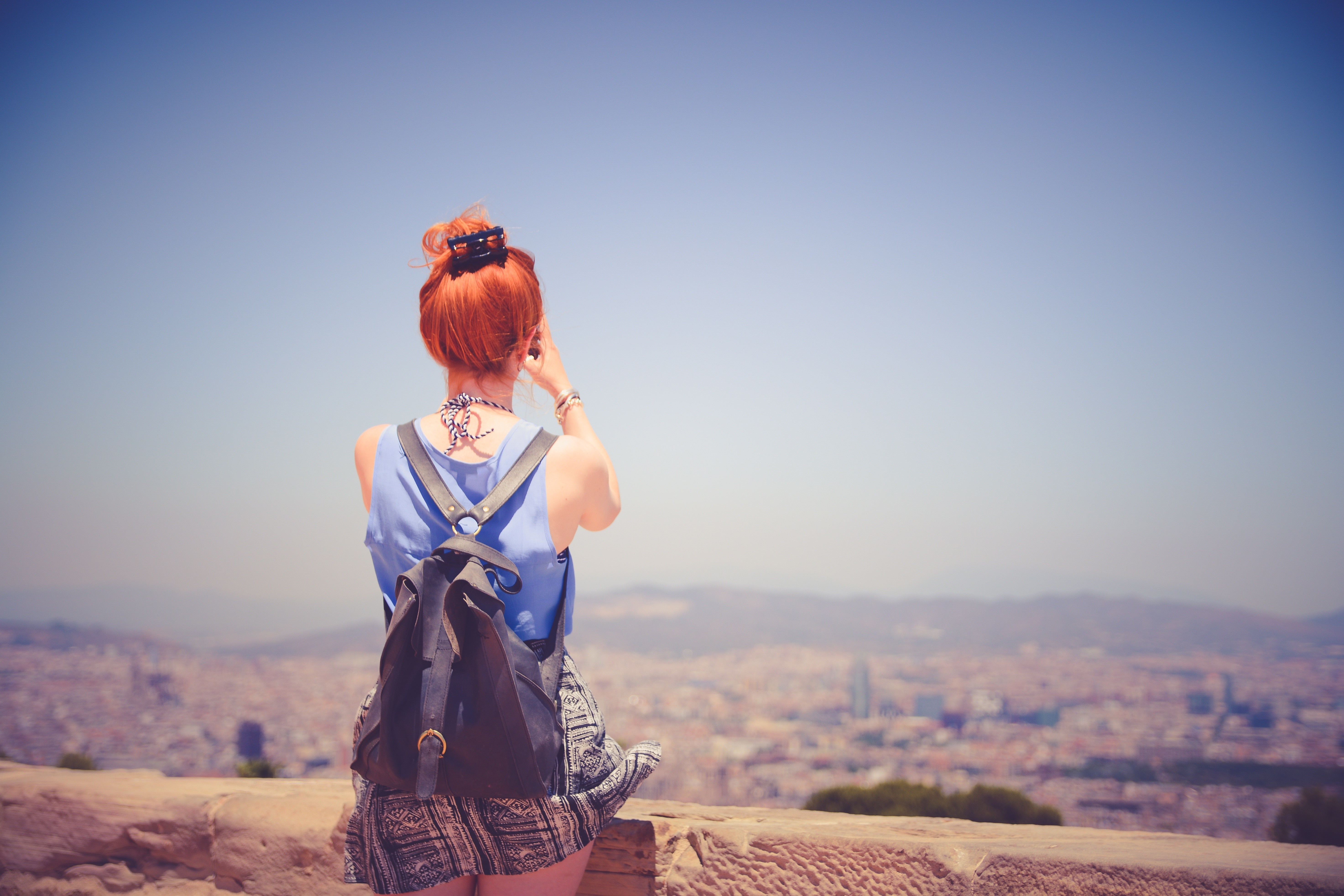 Woman with red hair taking a photo of a city HD Wallpaper