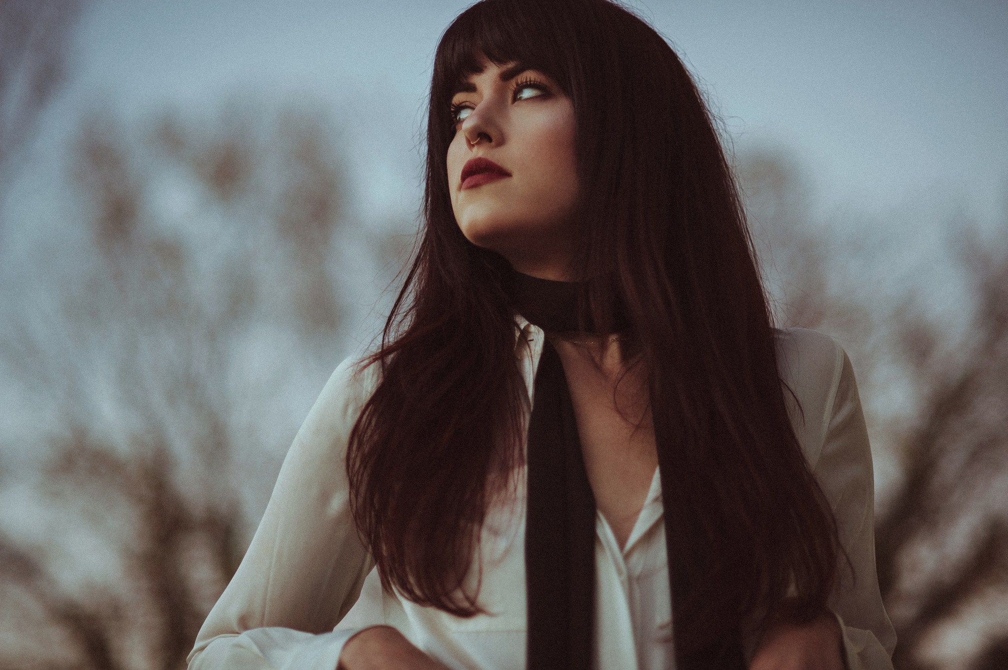 Woman with long dark hair and red lipstick looking away HD Wallpaper