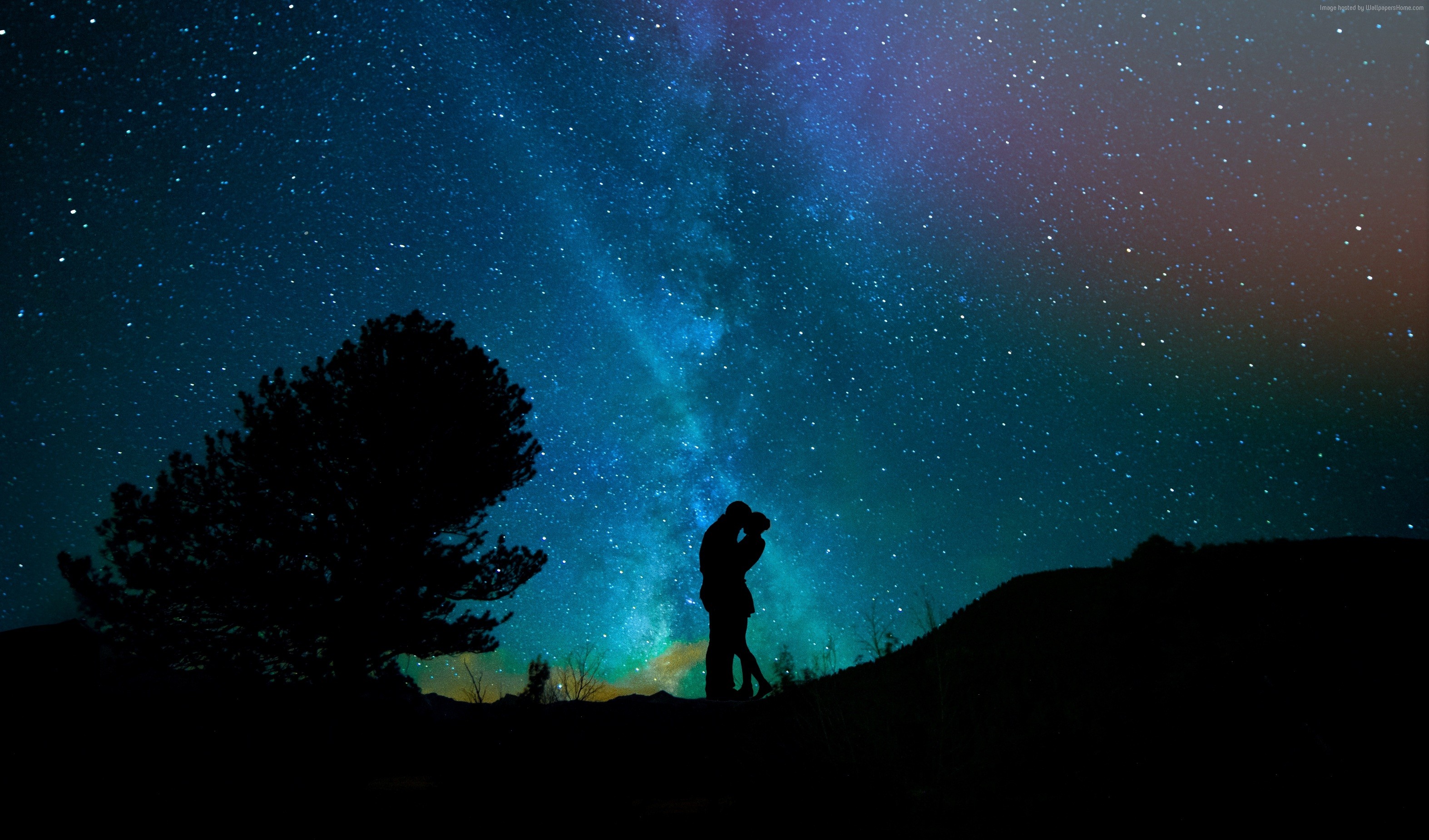 Couple kissing under the starry night sky HD Wallpaper