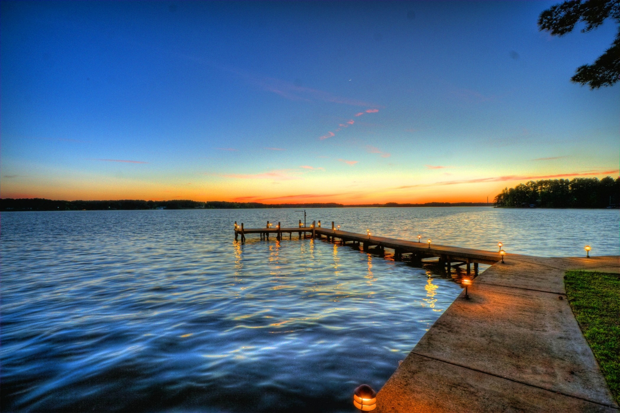 Wooden dock with lights on a lake at sunset HD Wallpaper