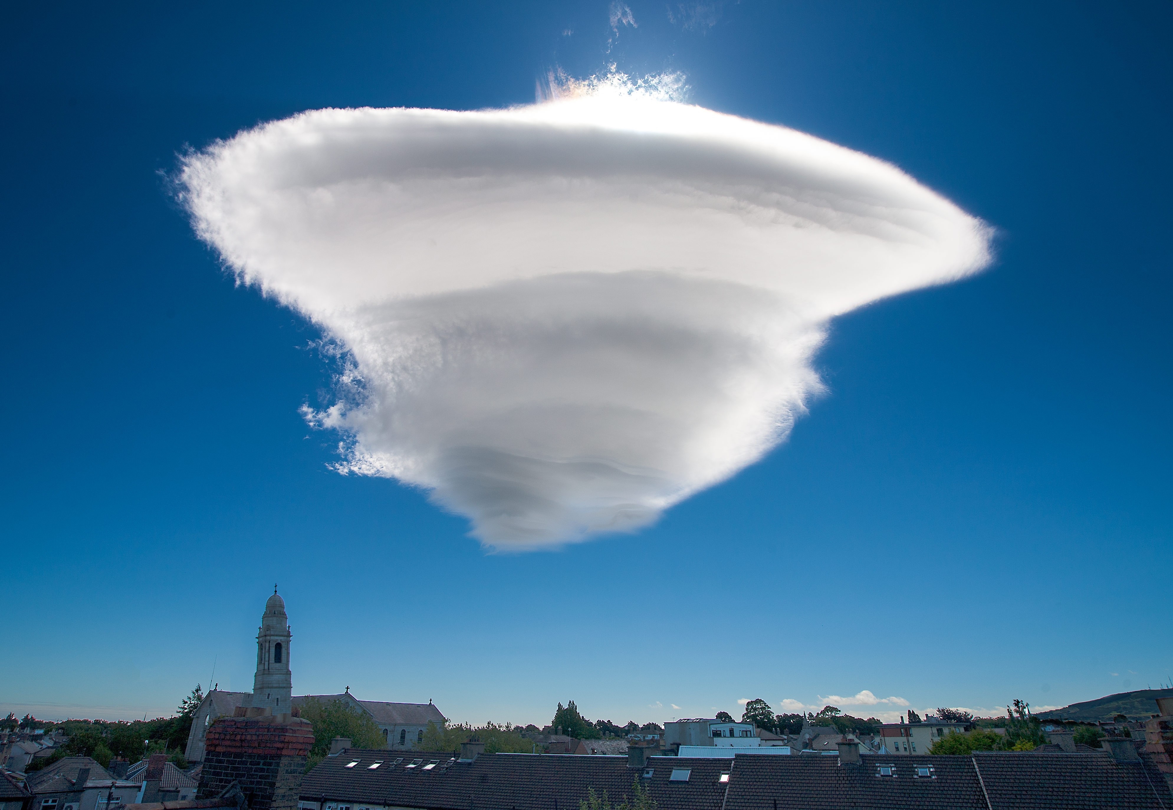 Lenticular cloud formation over a town HD Wallpaper