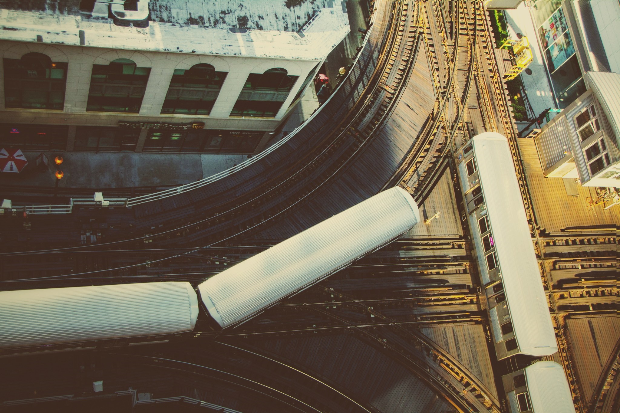 Elevated train tracks and trains in a city HD Wallpaper