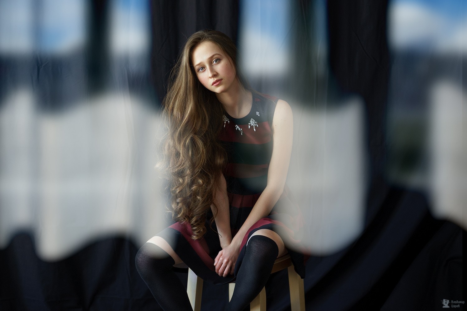 Woman with long curly hair wearing a striped dress and socks HD Wallpaper