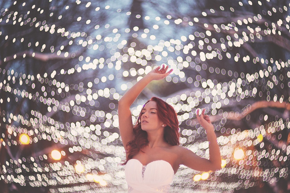 Woman in white dress with red hair dancing among lights HD Wallpaper