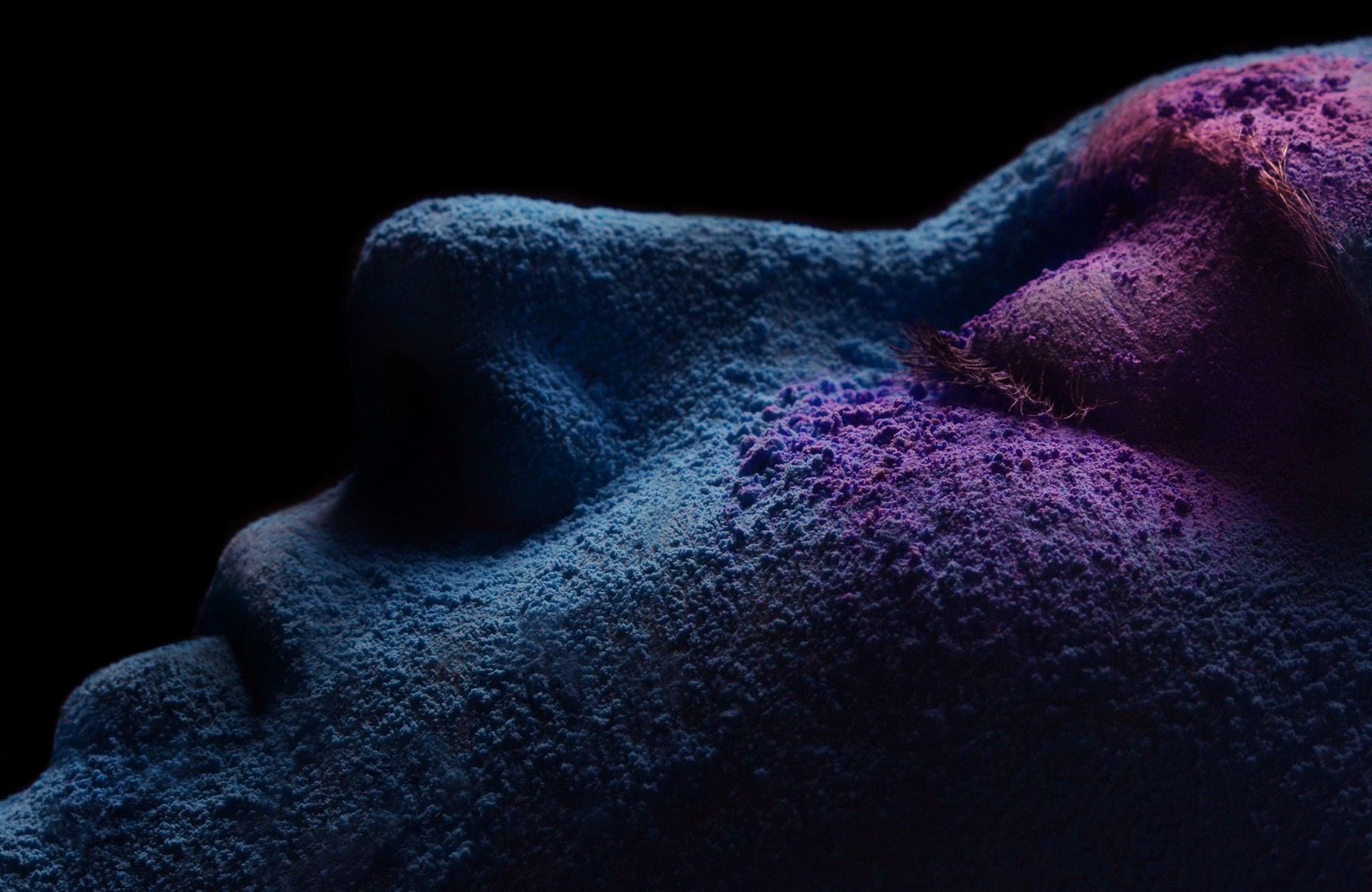 Close-up of face covered in blue and purple pigments HD Wallpaper