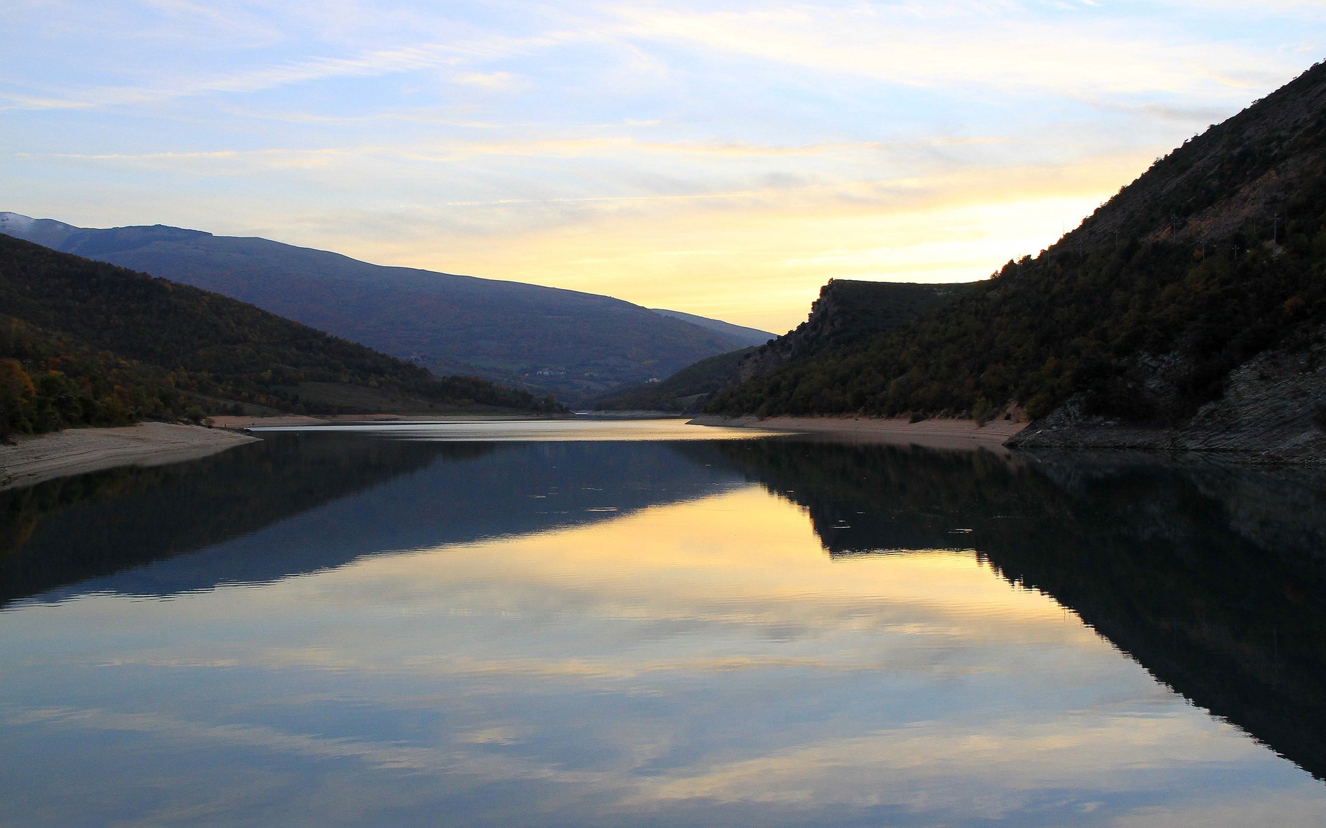 Calm lake reflecting mountains and sky at sunset HD Wallpaper