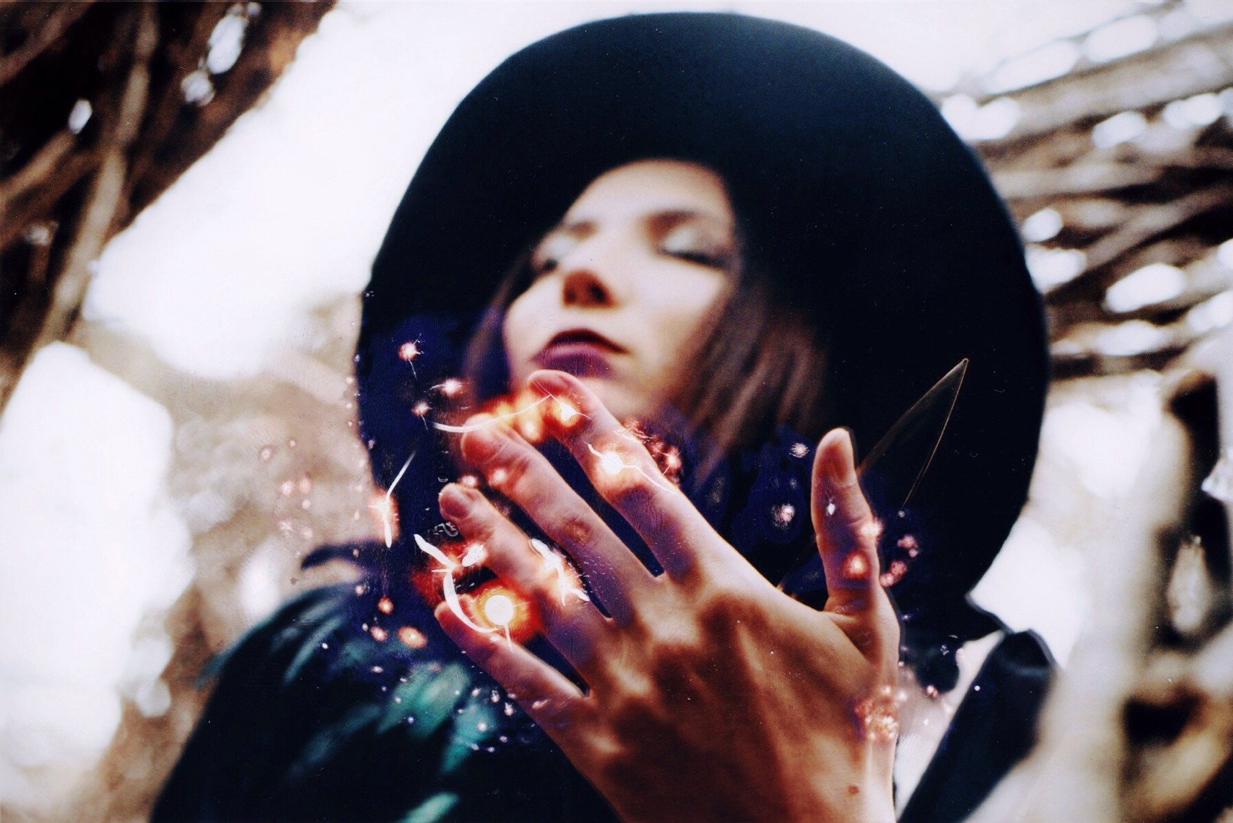 Woman in black hat with glowing hands HD Wallpaper
