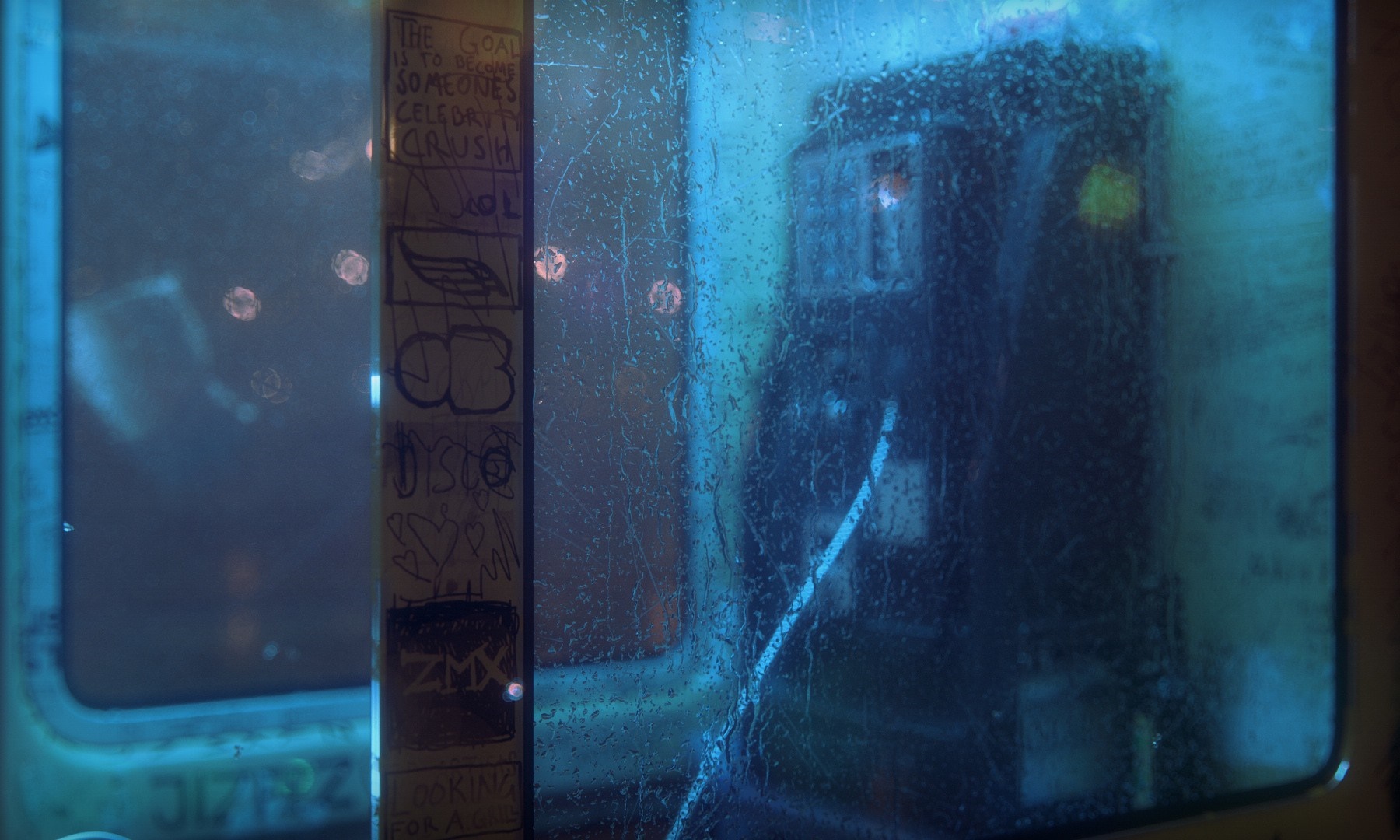 Graffiti on a rainy phone booth HD Wallpaper