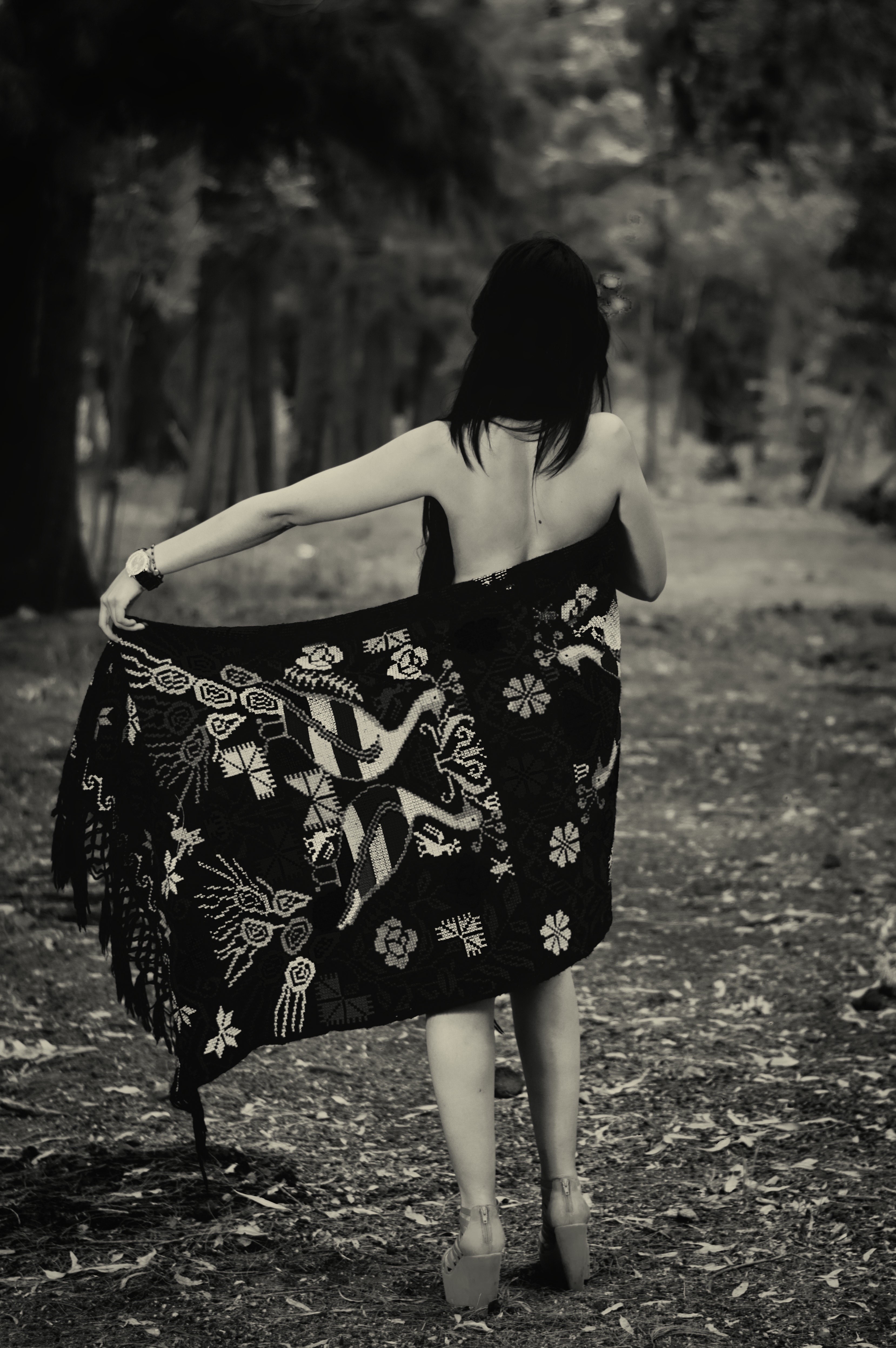 Woman in patterned shawl in a forest HD Wallpaper