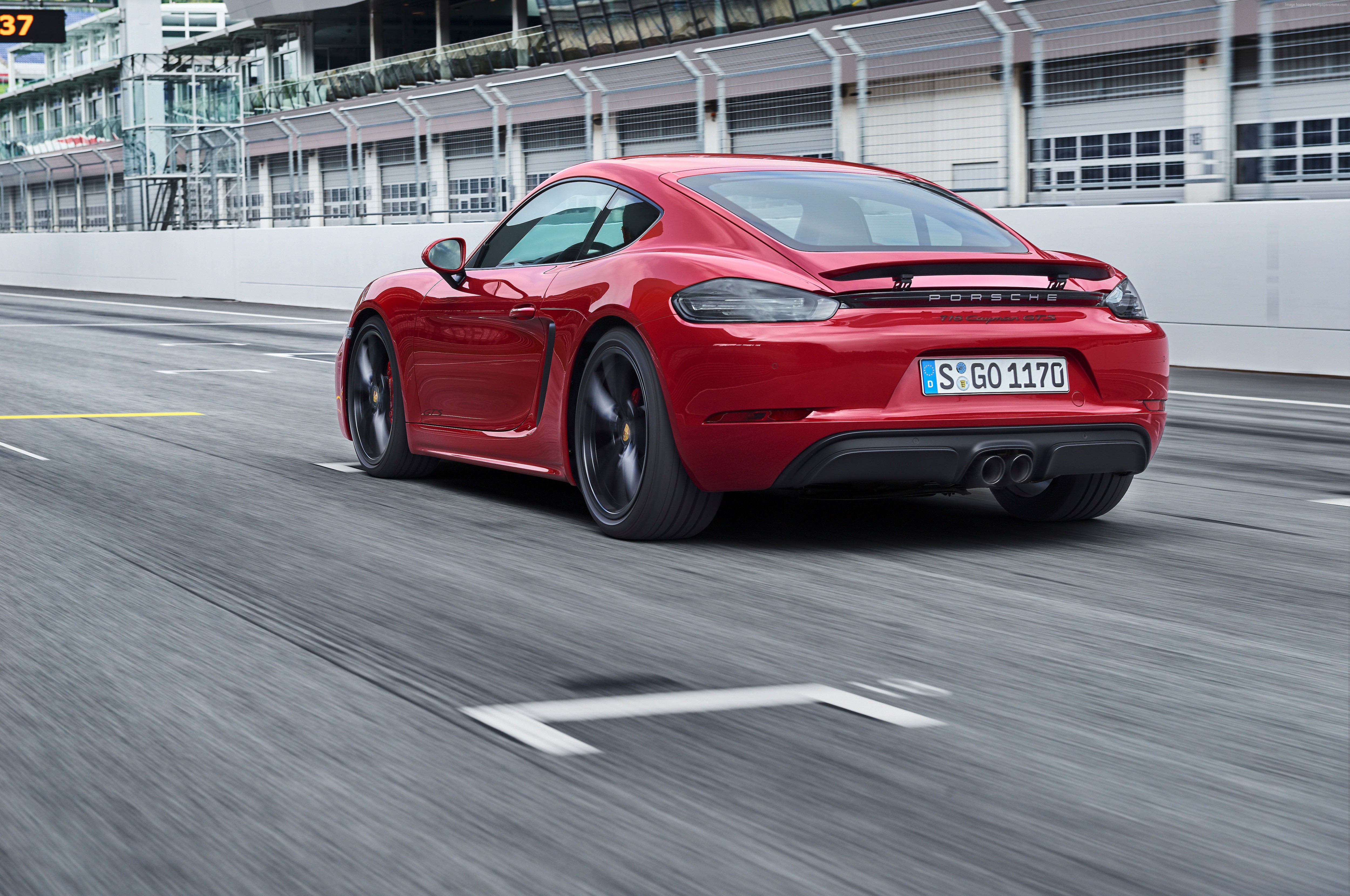 Red Porsche 718 Cayman GTS on a race track HD Wallpaper