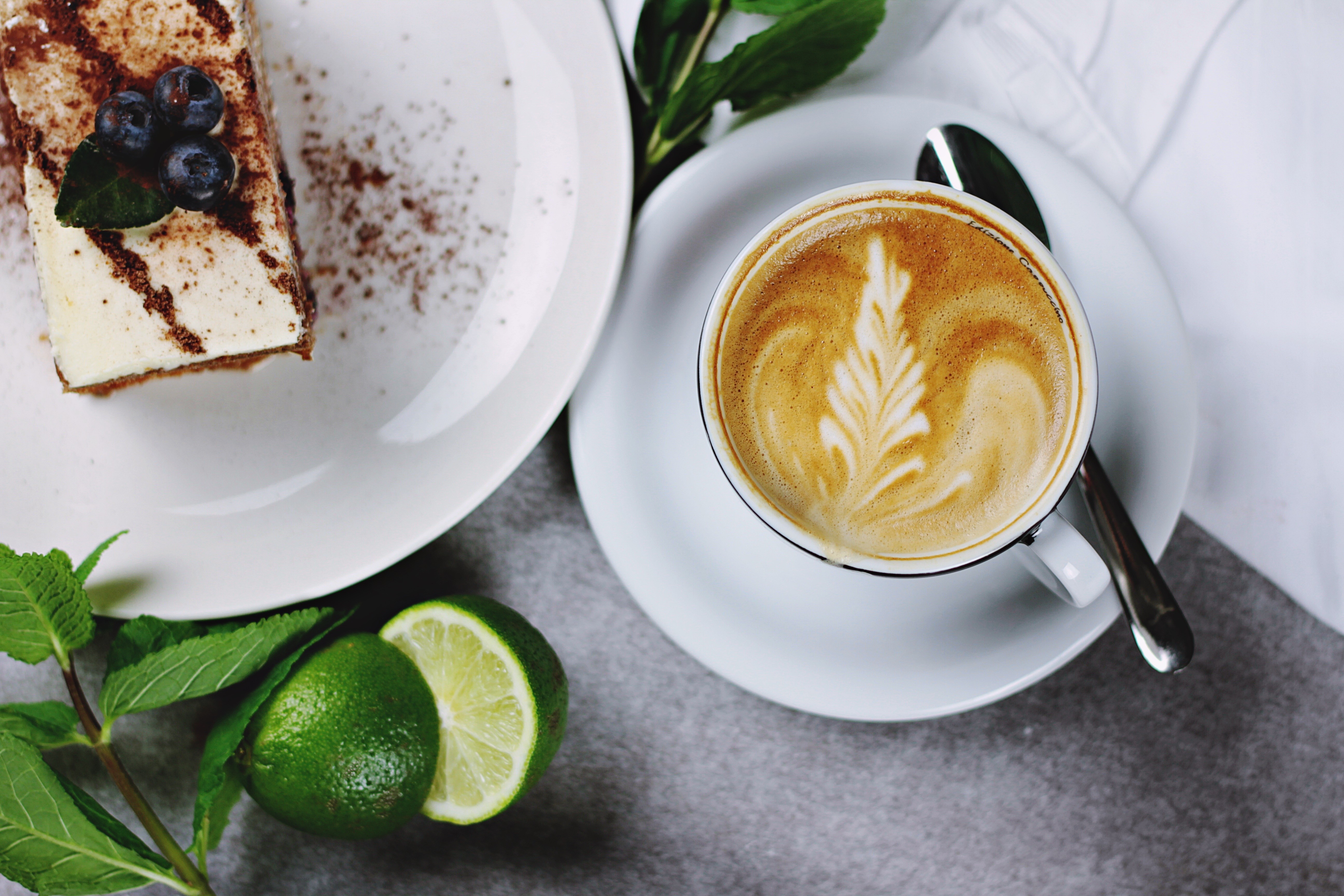 Slice of cake with blueberries and latte art coffee HD Wallpaper