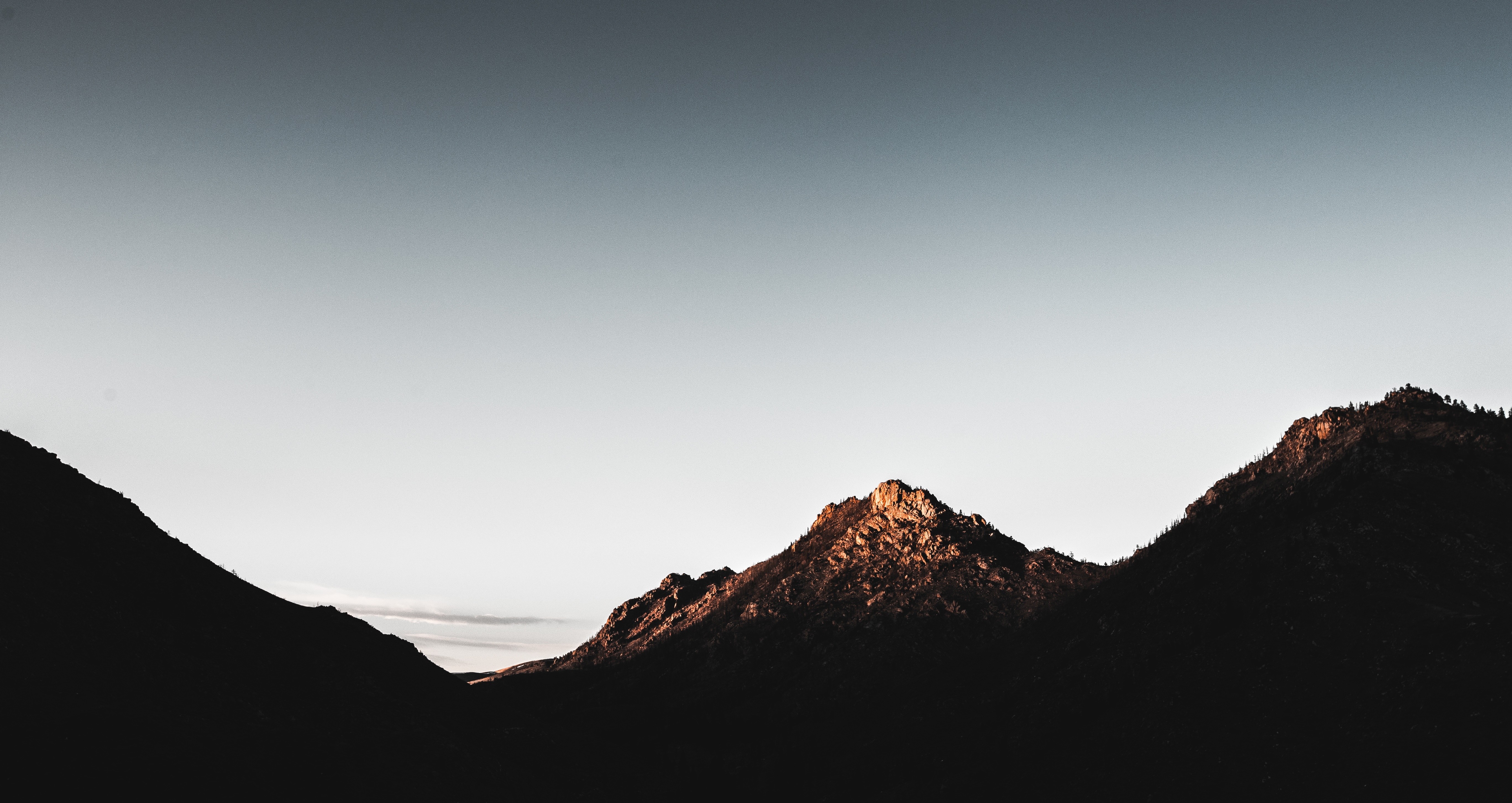 Sunlight on Mountain Peaks at Dusk HD Wallpaper