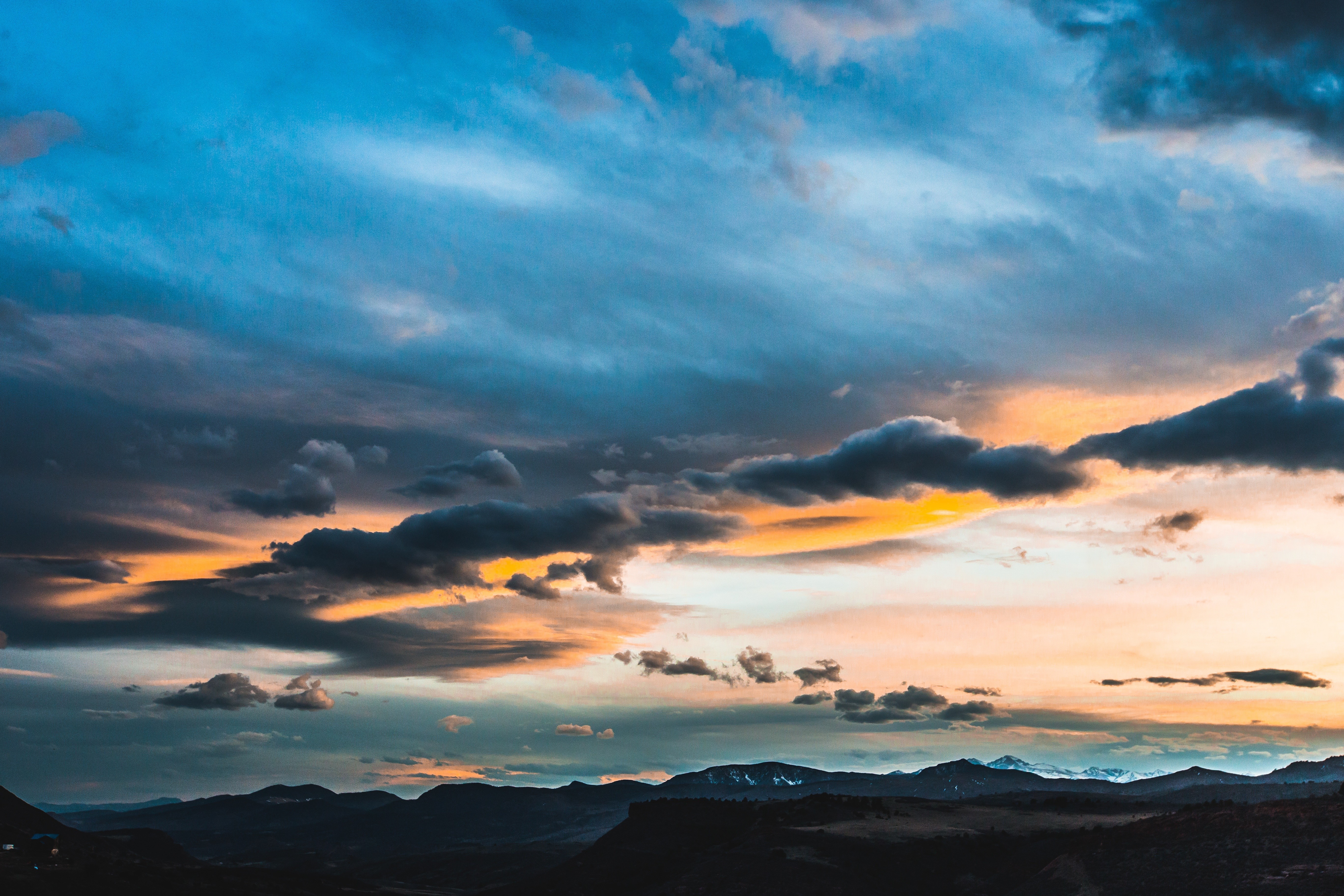 Sunset over mountains with dramatic clouds HD Wallpaper