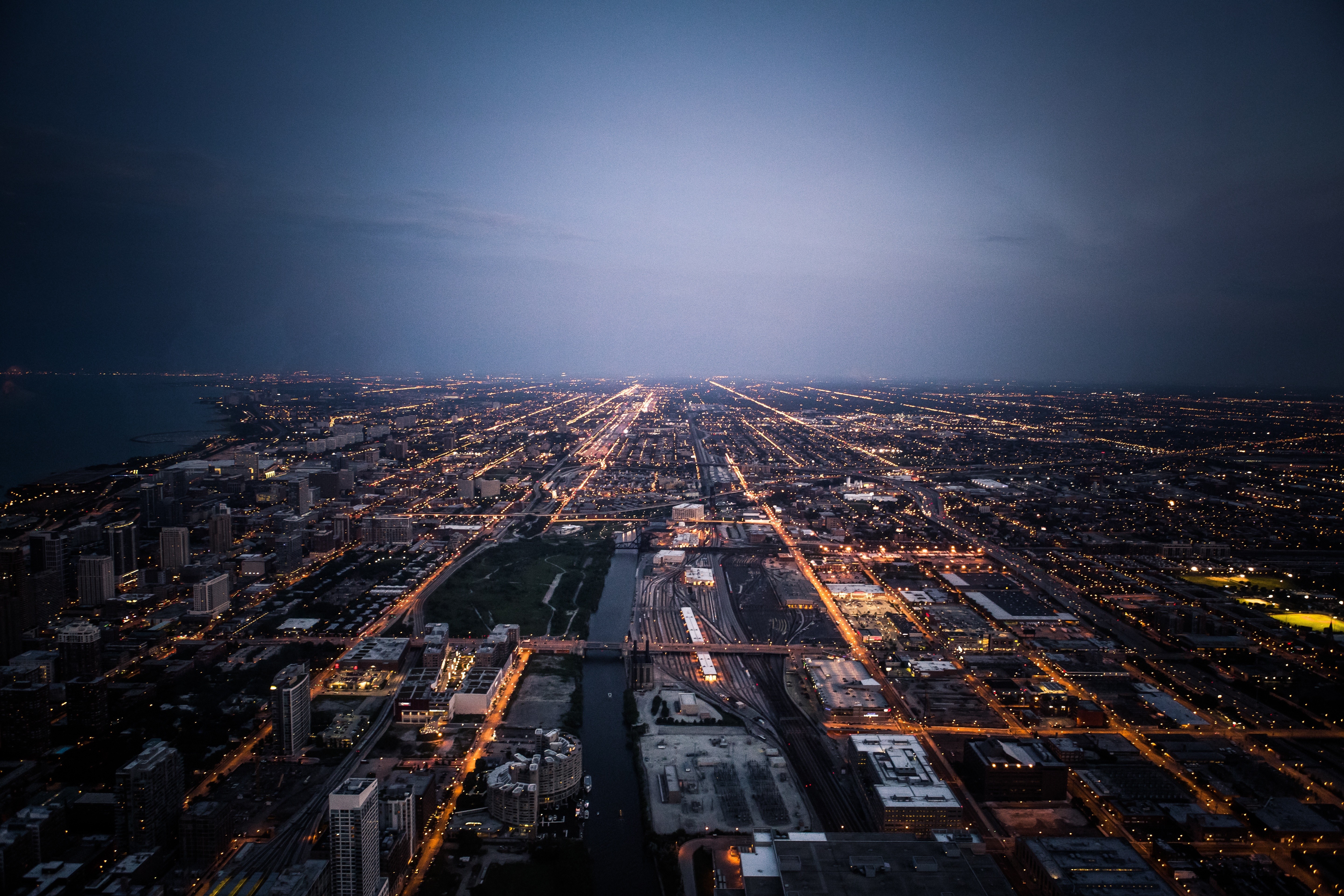Aerial view of Chicago cityscape at dusk with lights HD Wallpaper