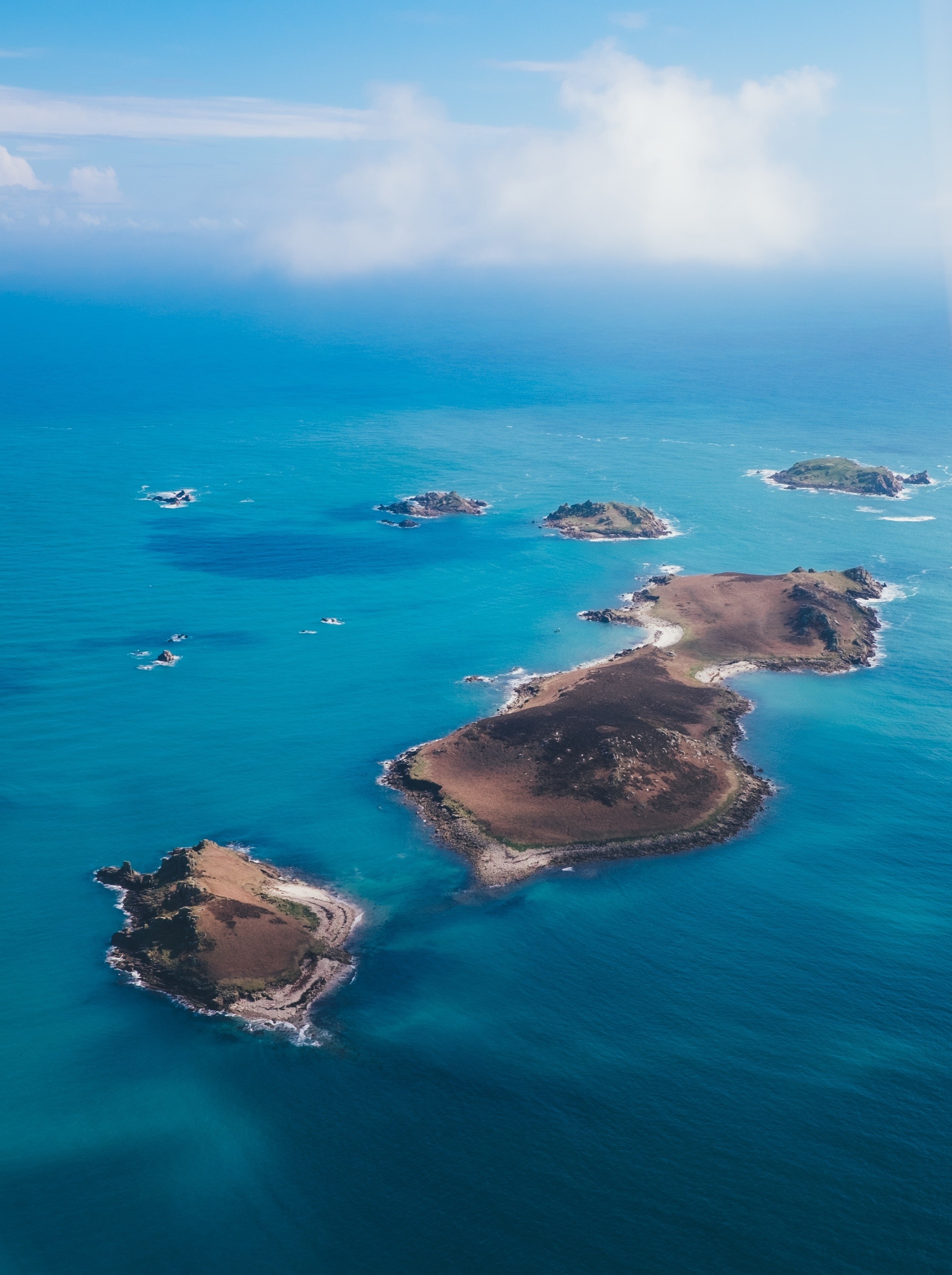 Aerial view of a rocky archipelago in the ocean HD Wallpaper