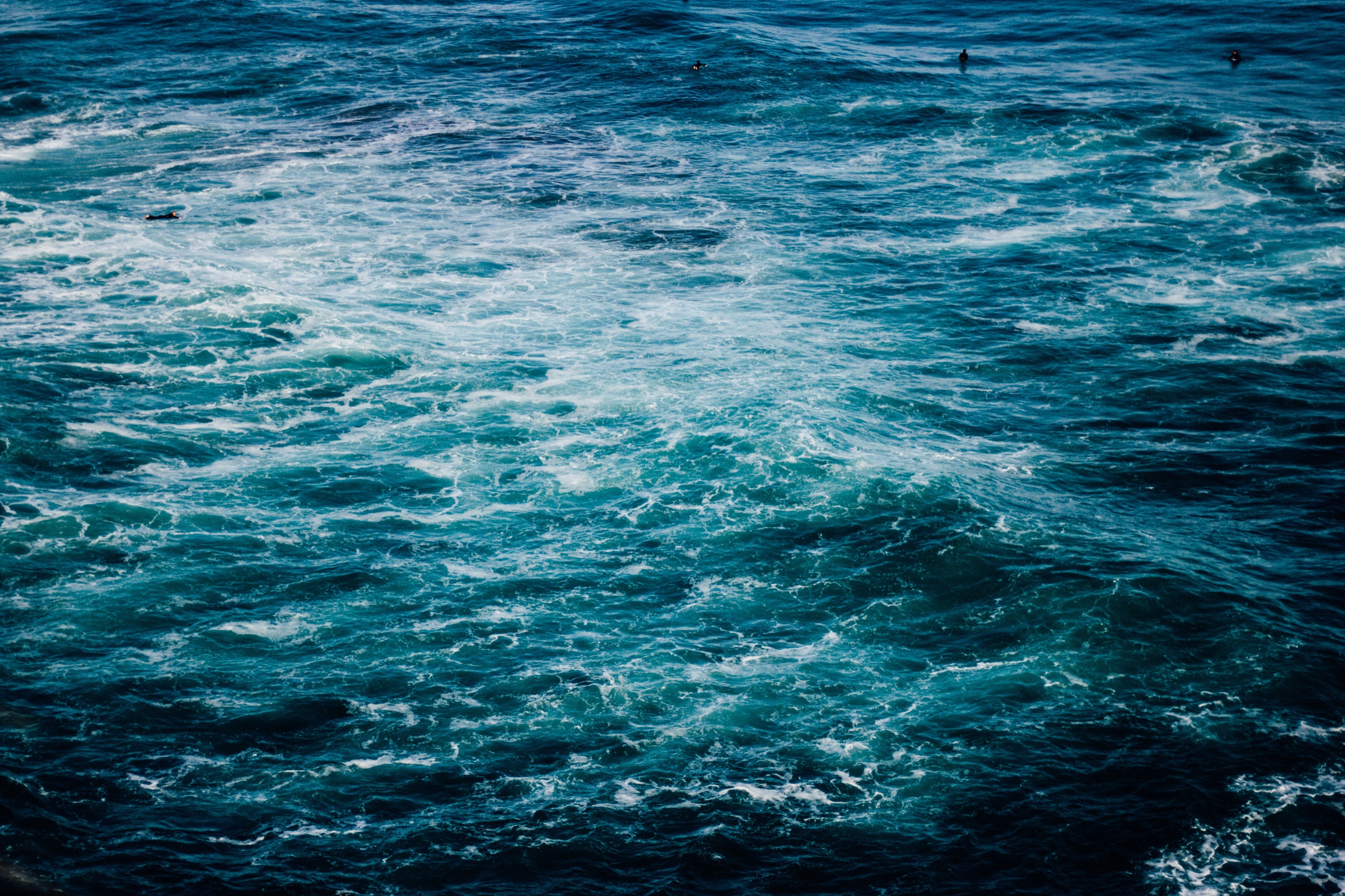 Ocean waves with surfers HD Wallpaper