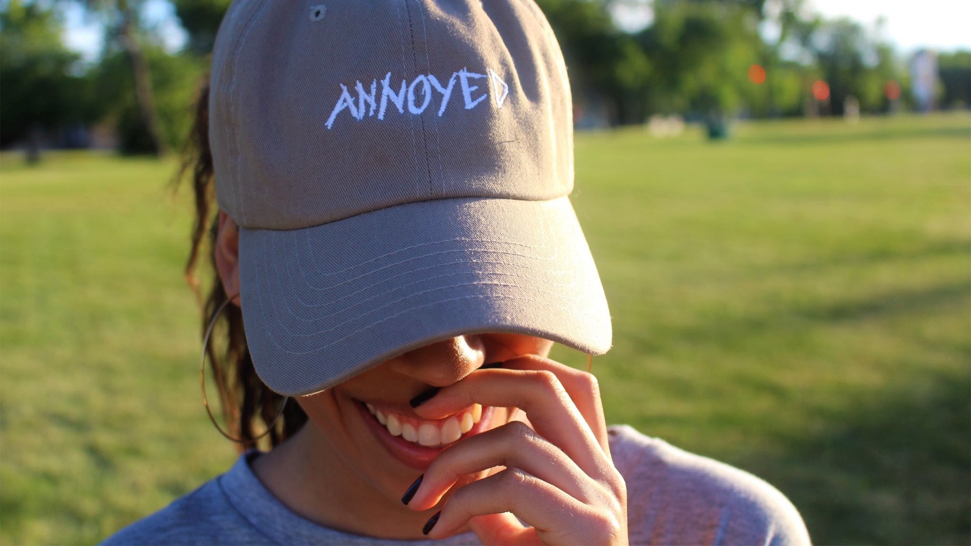 Woman wearing a hat with the word "ANNOYED" HD Wallpaper