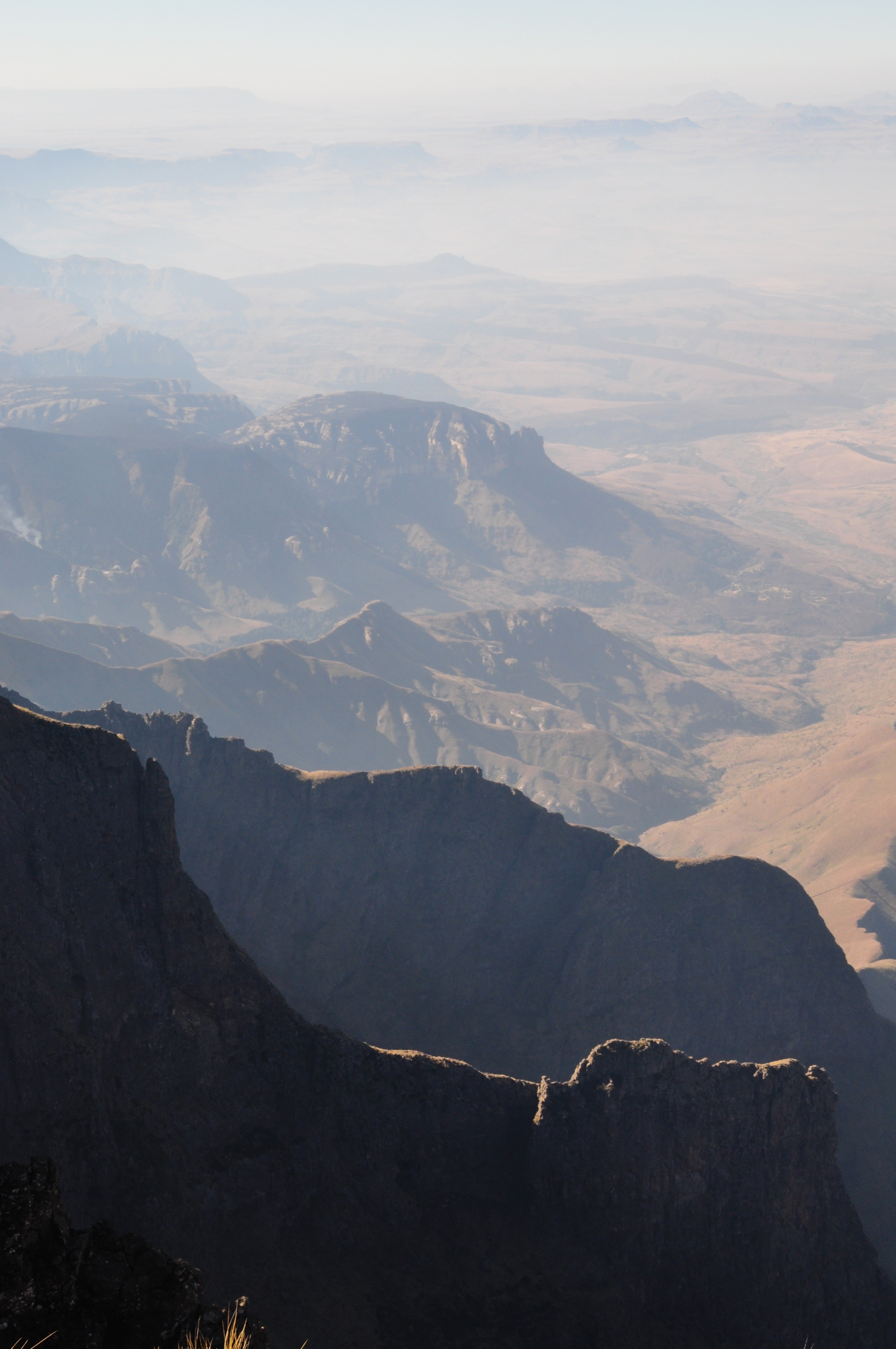 Mountain range with valleys and atmospheric haze HD Wallpaper