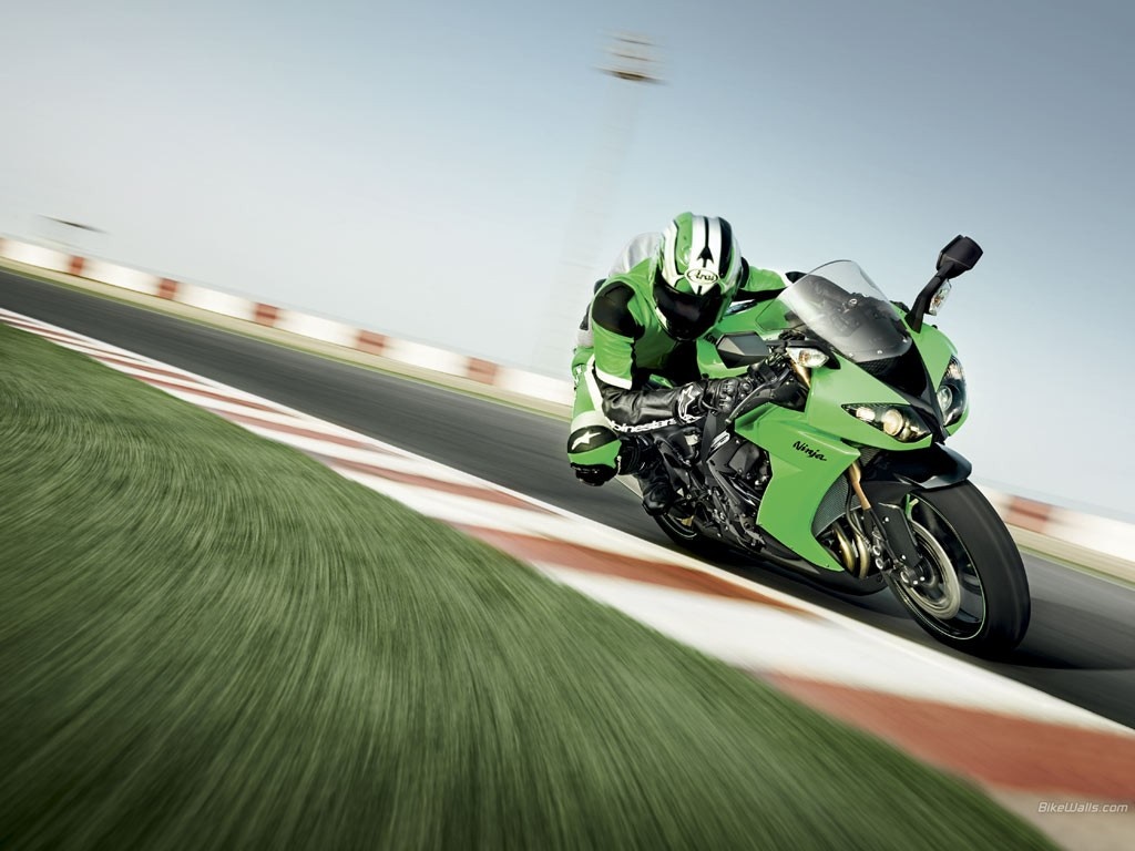 Green Kawasaki Ninja motorcycle on a race track HD Wallpaper