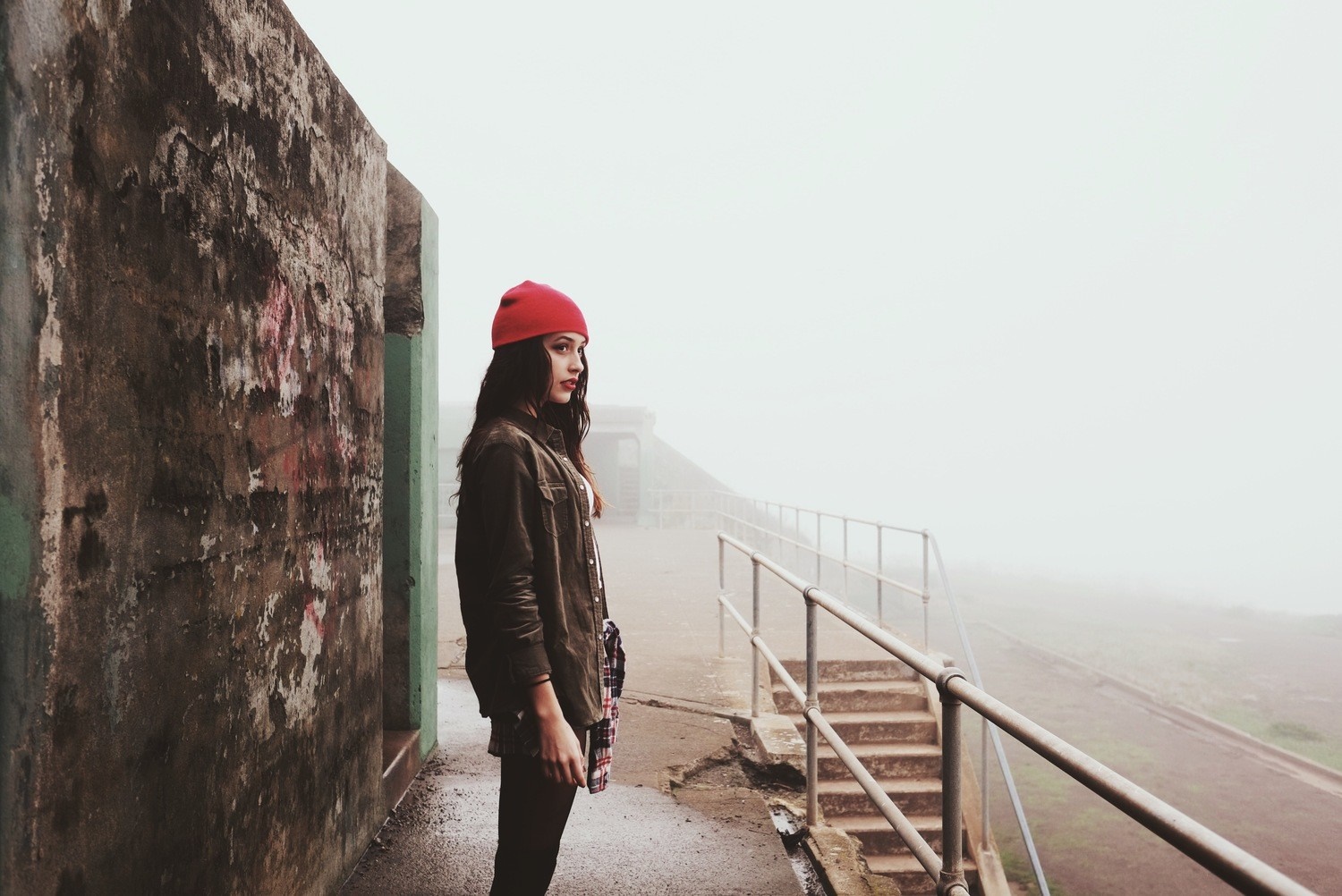 Woman in Red Hat Standing by Concrete Wall in Fog HD Wallpaper
