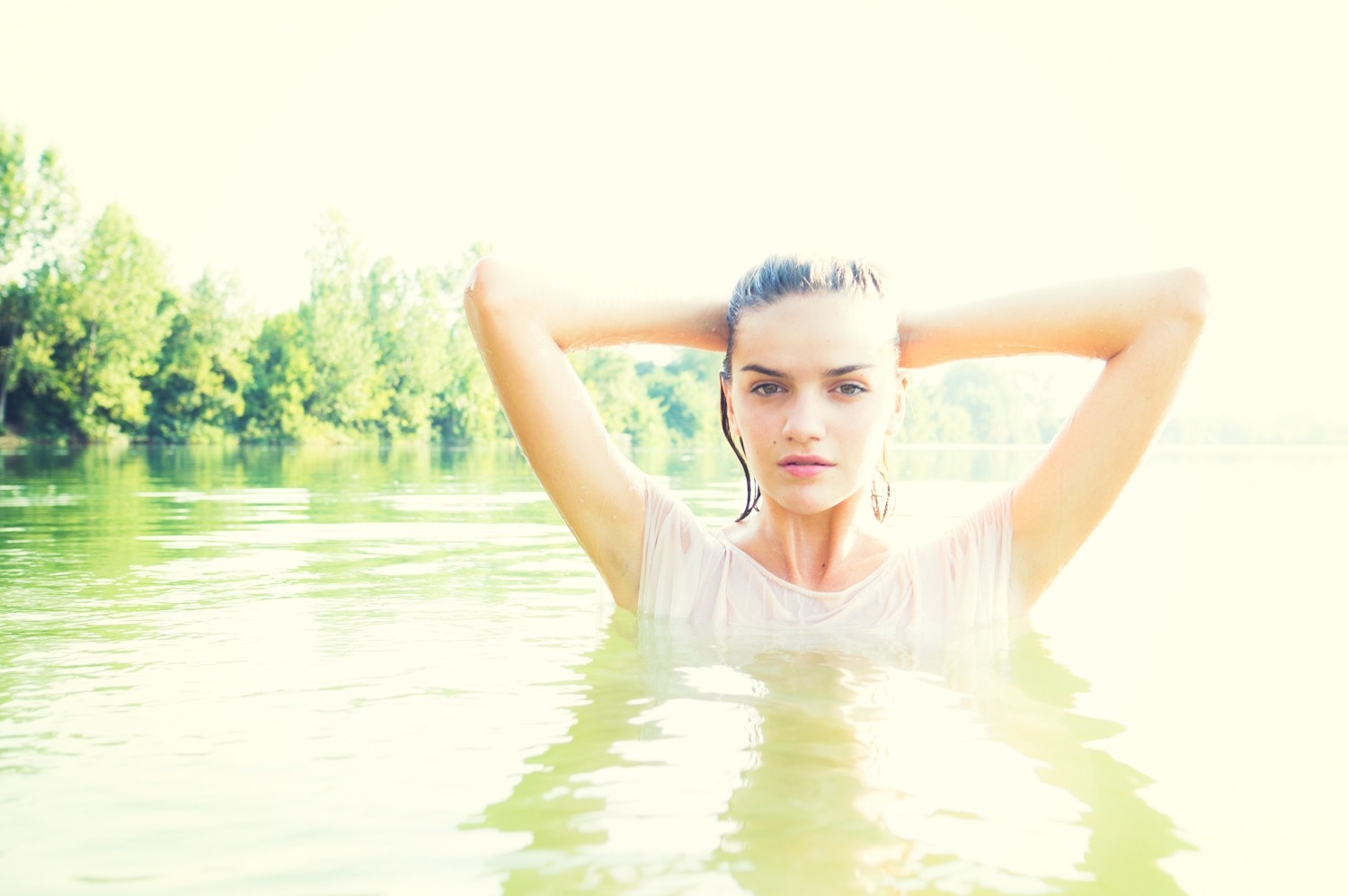 Woman with hands on head in water HD Wallpaper