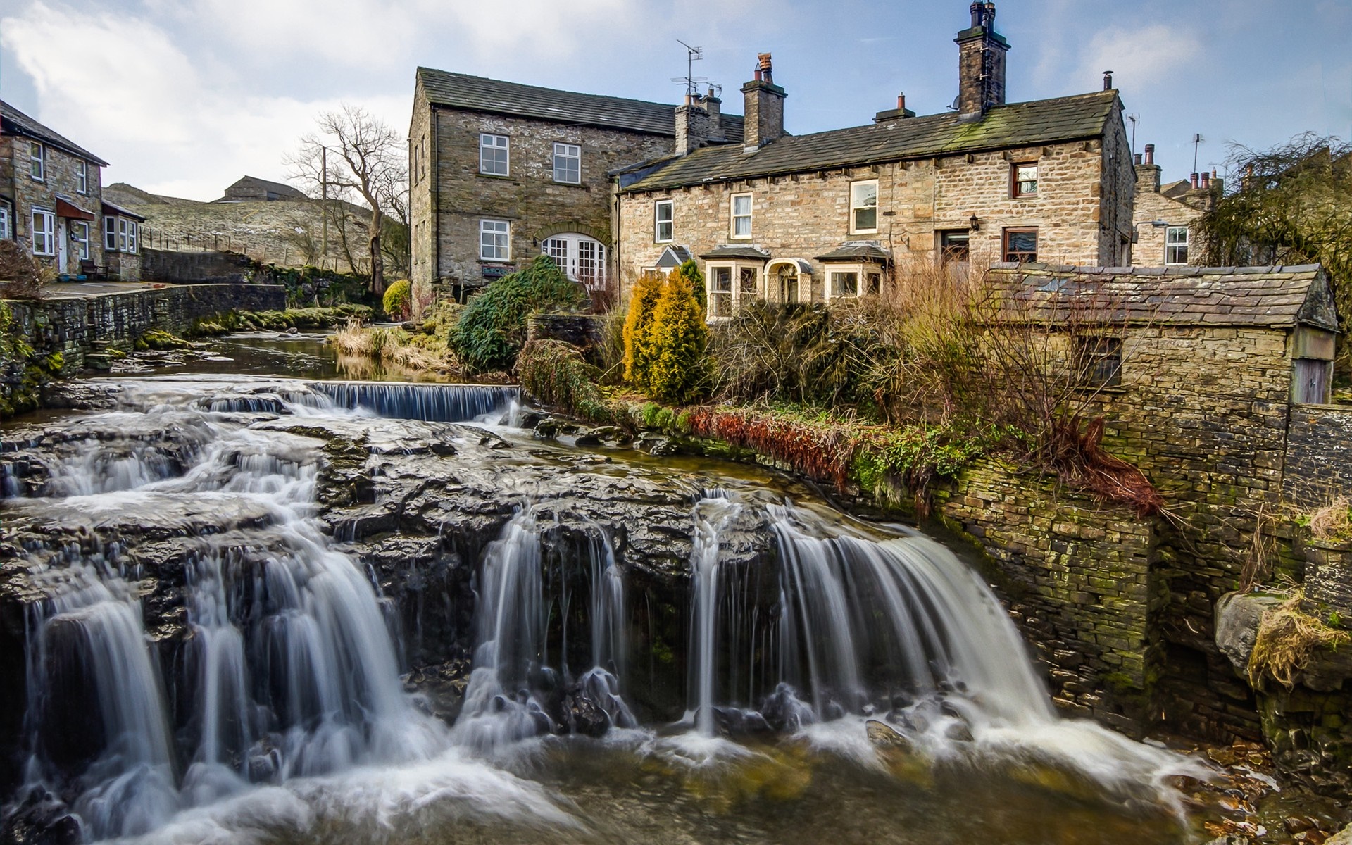 Village with waterfall and stone buildings in England HD Wallpaper