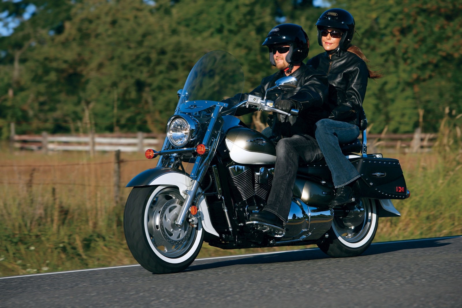 Couple riding a motorcycle on a road HD Wallpaper