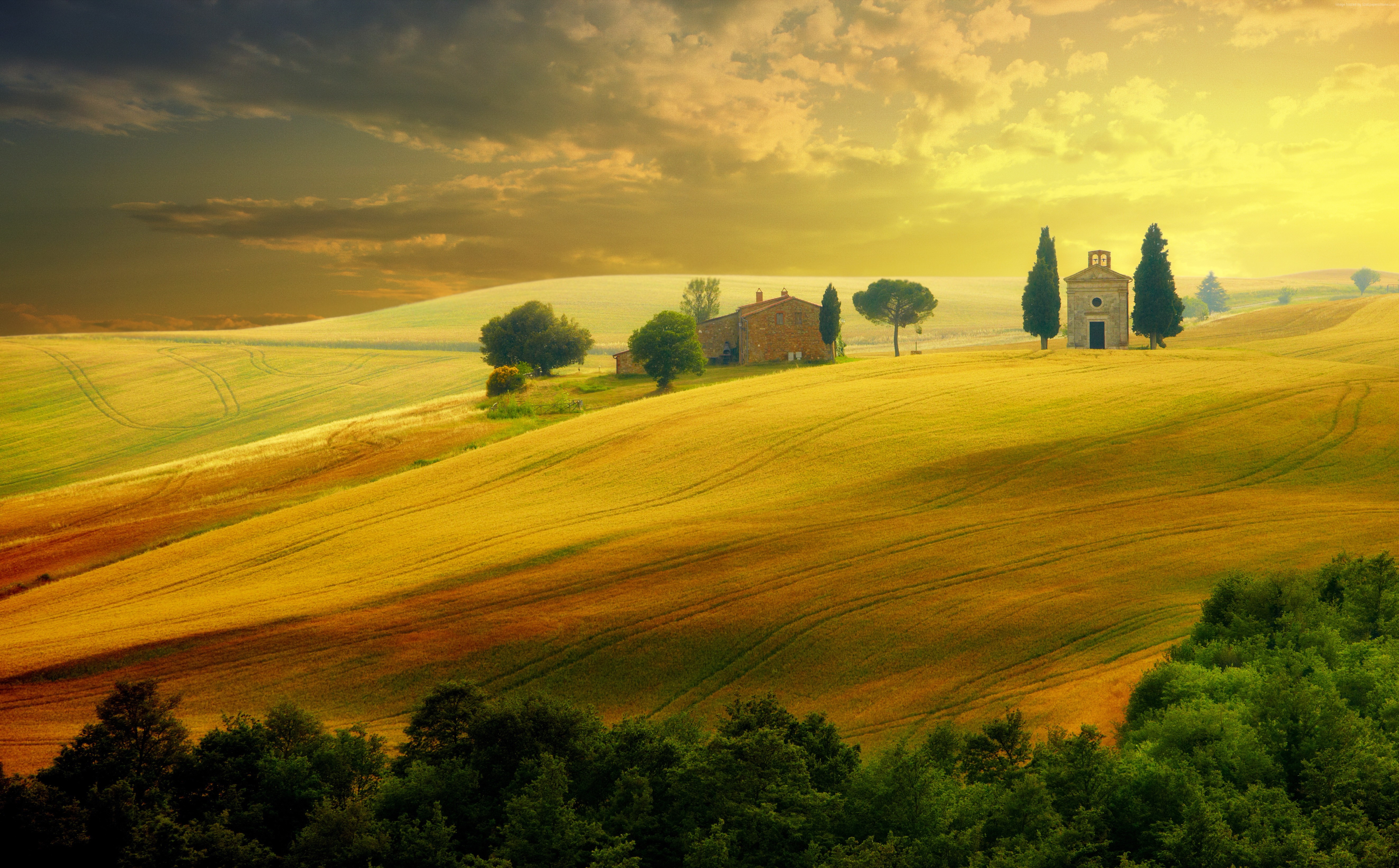 Tuscan landscape with rolling hills and buildings HD Wallpaper