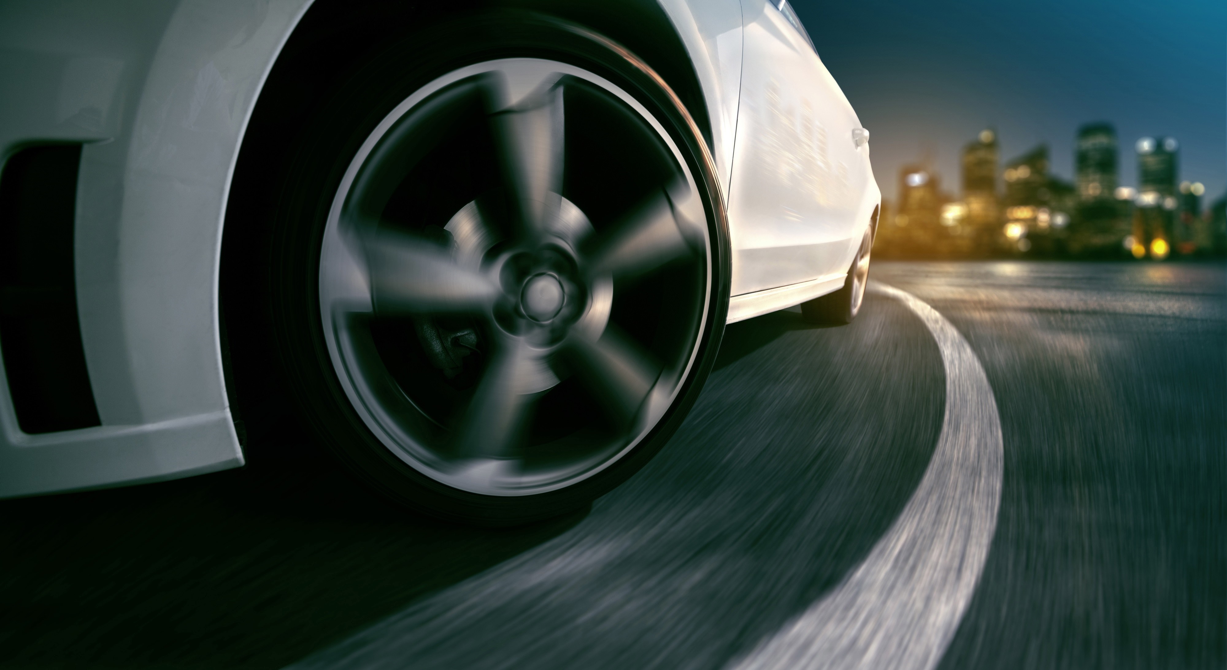 White car drifting on a city road at night HD Wallpaper