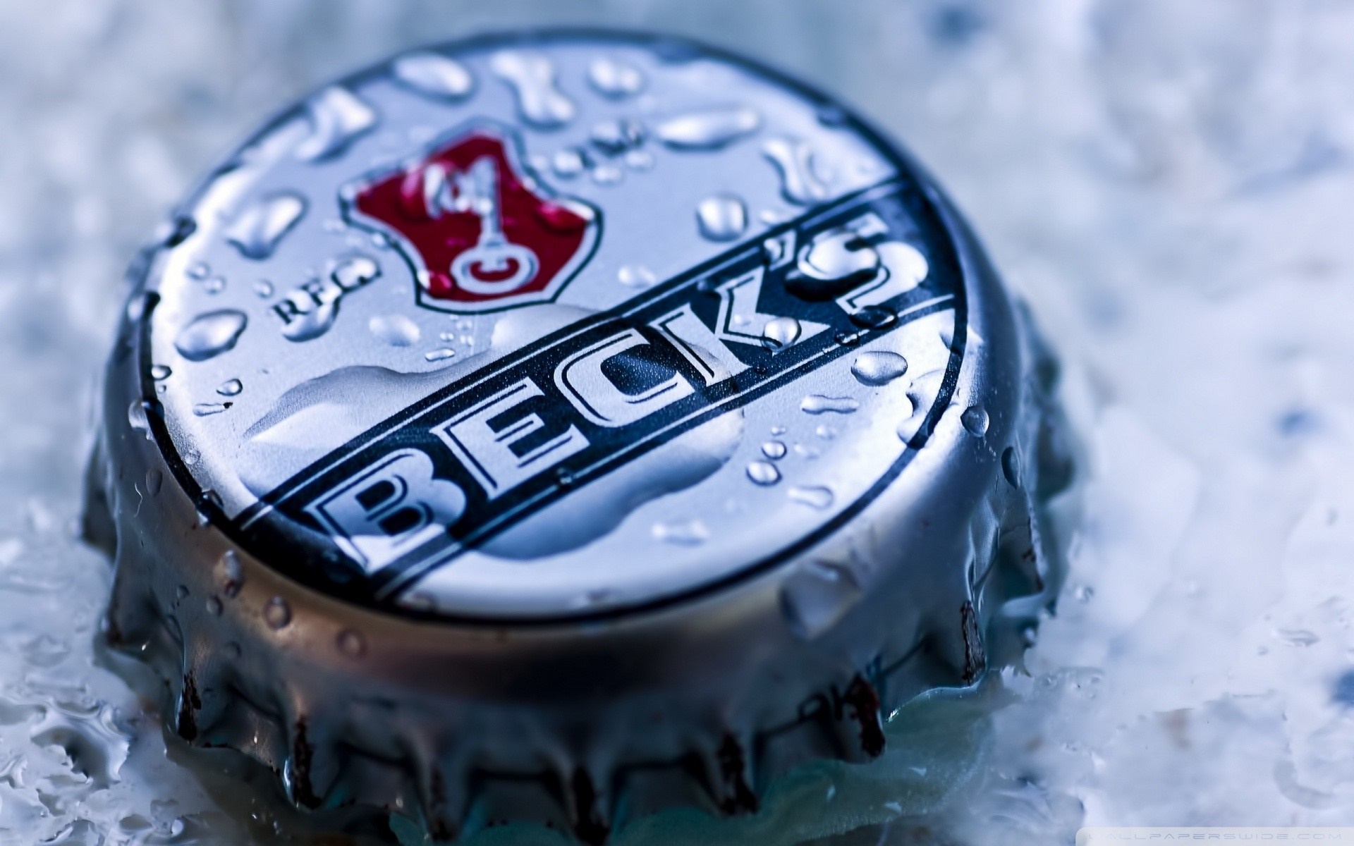 Close-up of a wet Beck's beer bottle cap HD Wallpaper