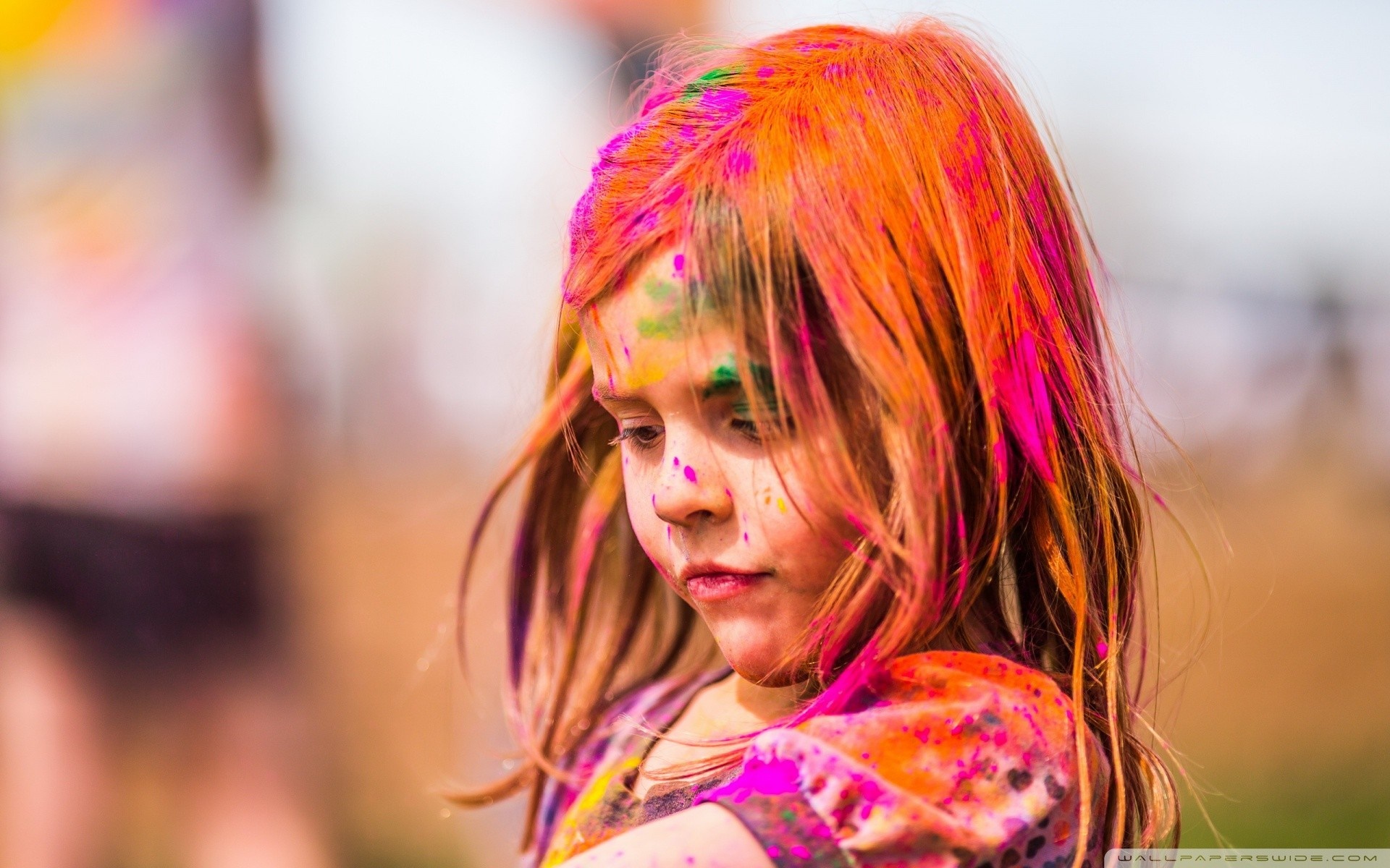 Young girl with colorful powder on her face and hair HD Wallpaper