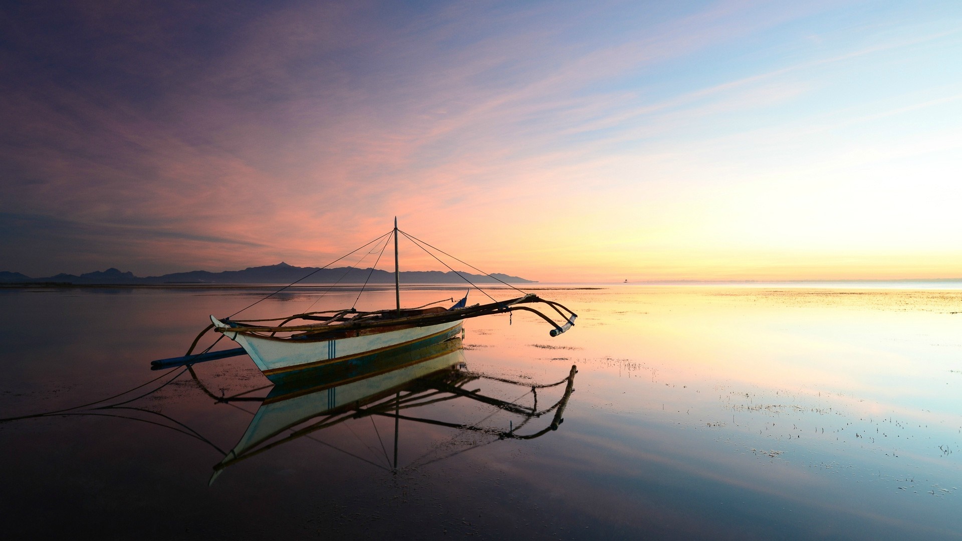 Boat on calm sea at sunset with mountain silhouette HD Wallpaper