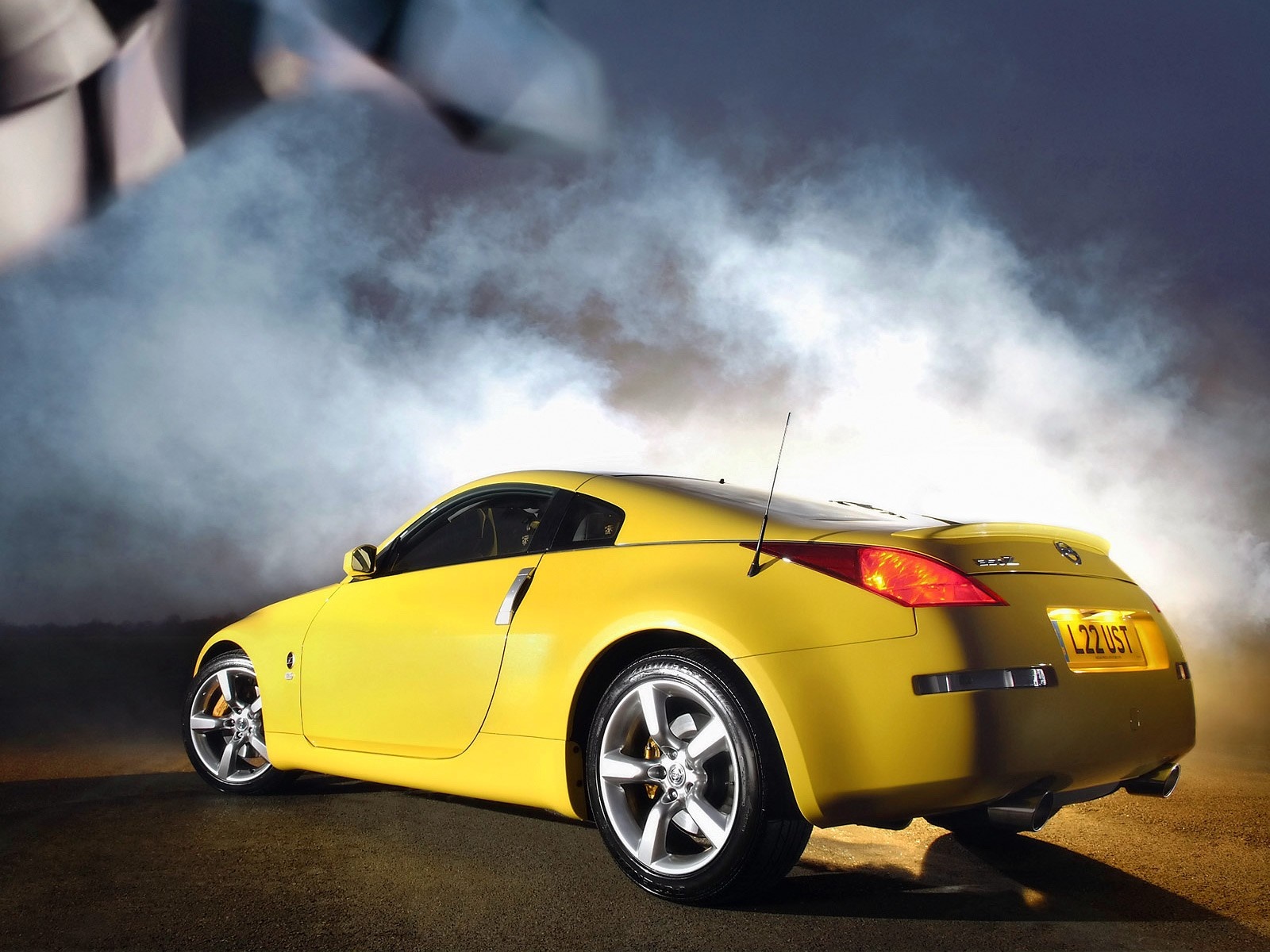 Yellow Nissan 350Z sports car with smoke HD Wallpaper