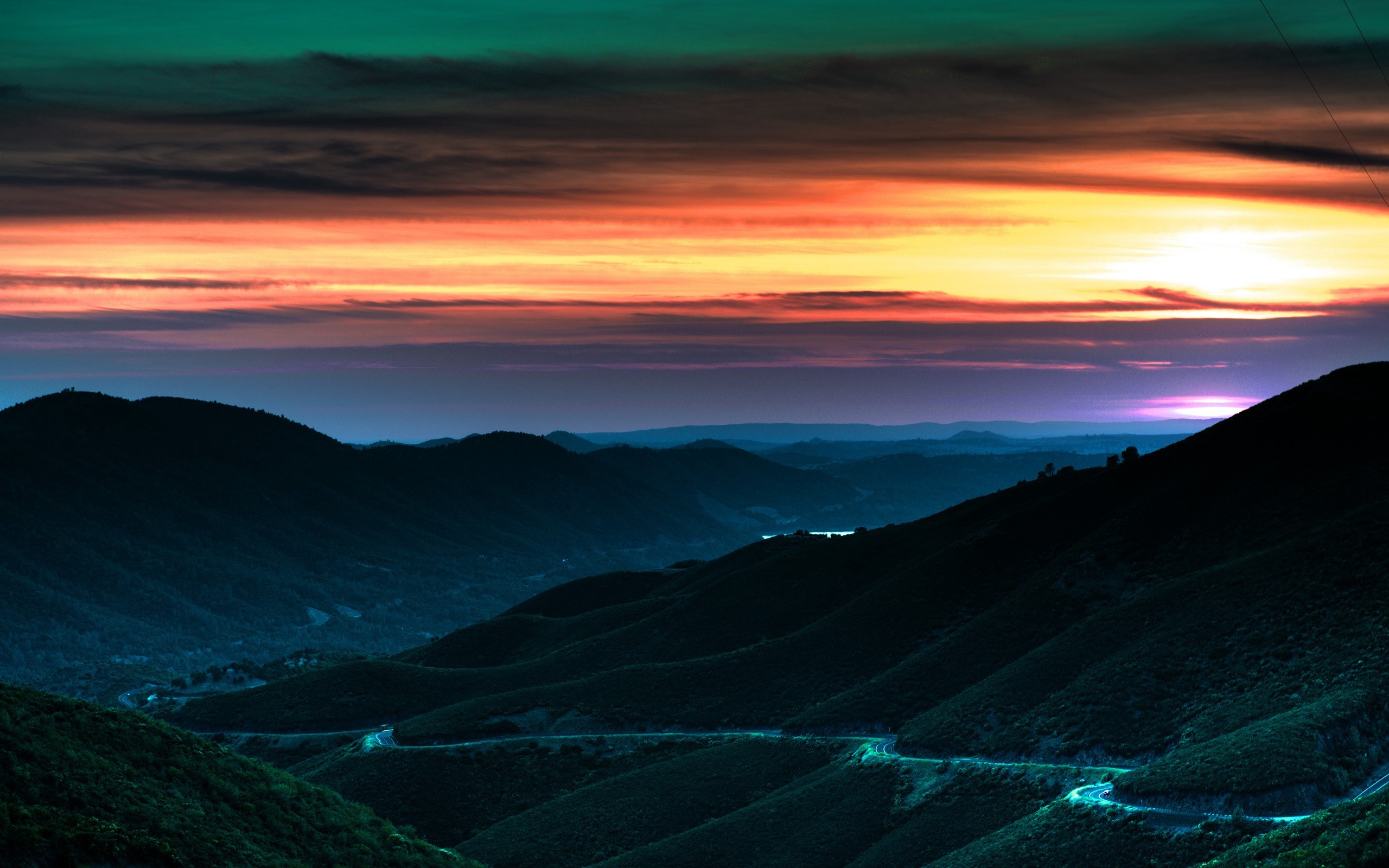 Mountain road at sunset with colorful sky HD Wallpaper